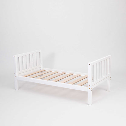 A Sweet Home From Wood Montessori-inspired raised kids' bed on legs with a headboard and footboard, with wooden slats on a white background.