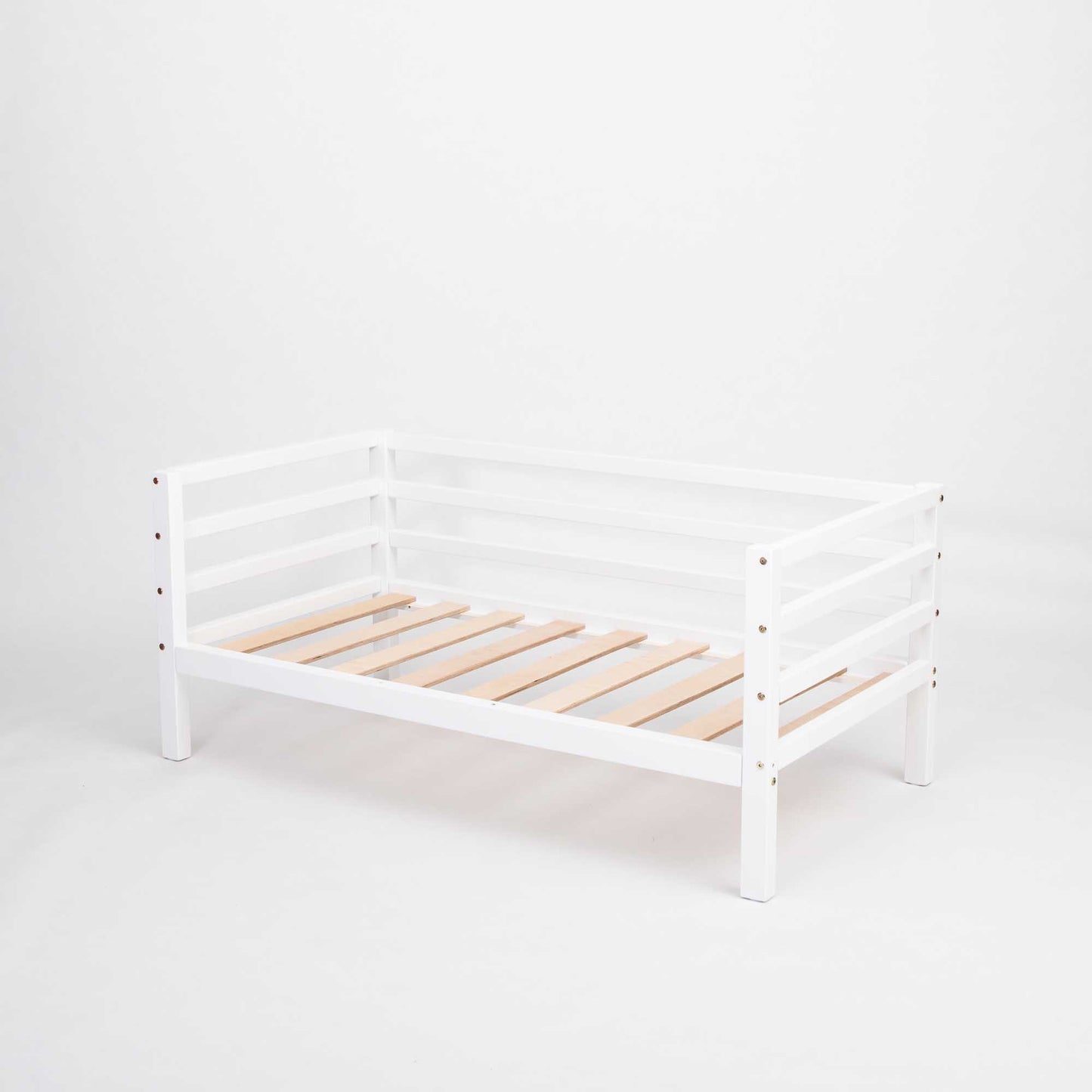 The Kids' bed on legs with horizontal rail on 3-sides, made of solid wood with slatted base and sides plus a safety rail, is displayed against a plain white background.