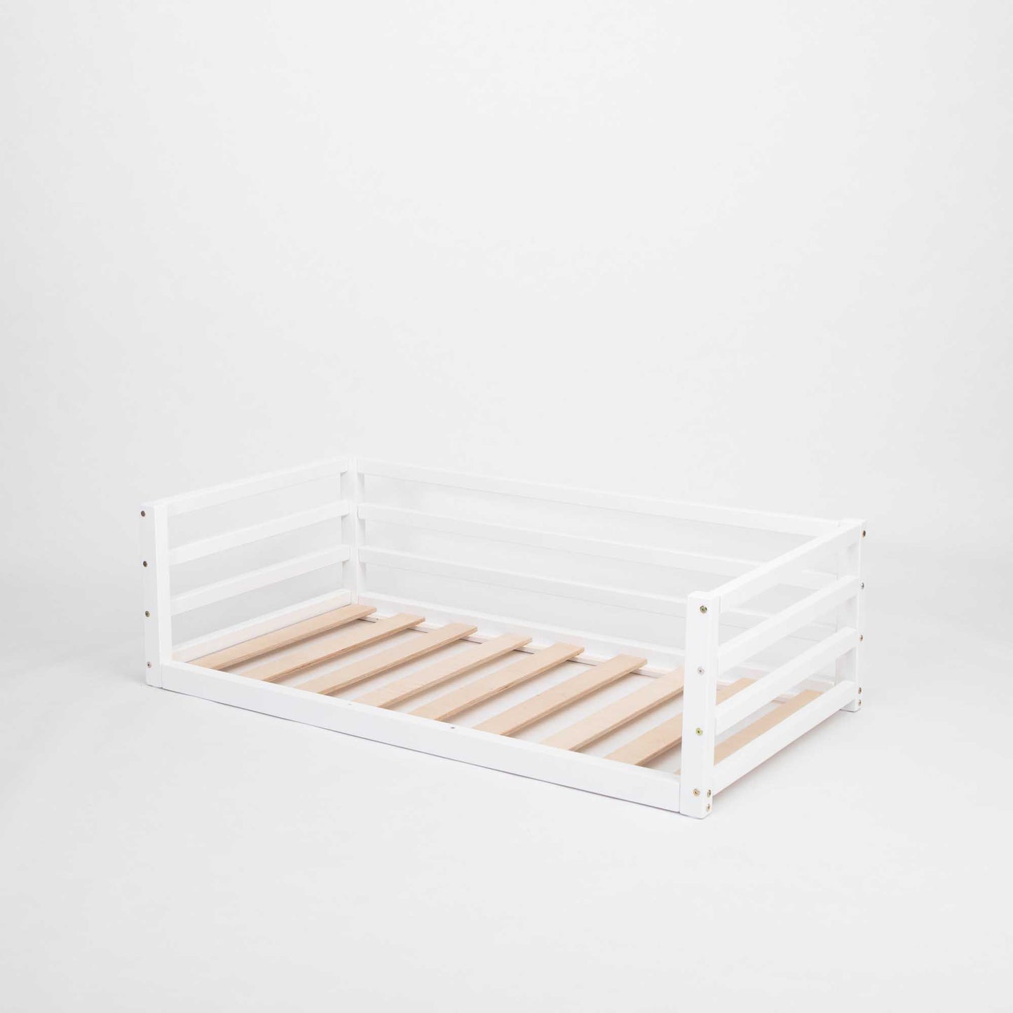 A Children's floor level bed with 3-sided safety rail from Sweet Home From Wood.