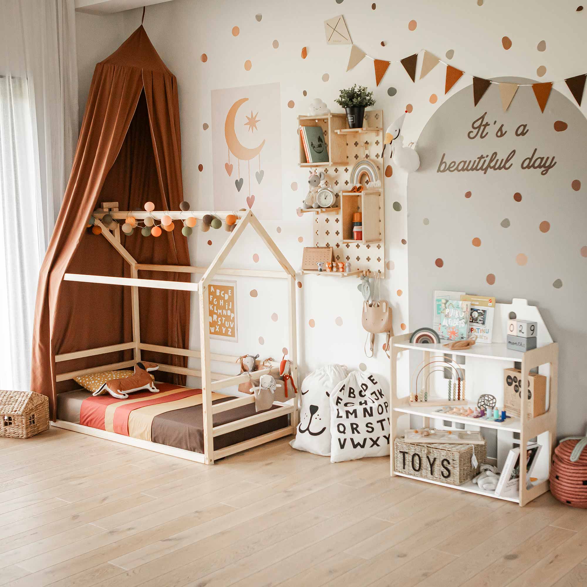 Girlroom with a Montessori toddler floor house bed and dollhouse
