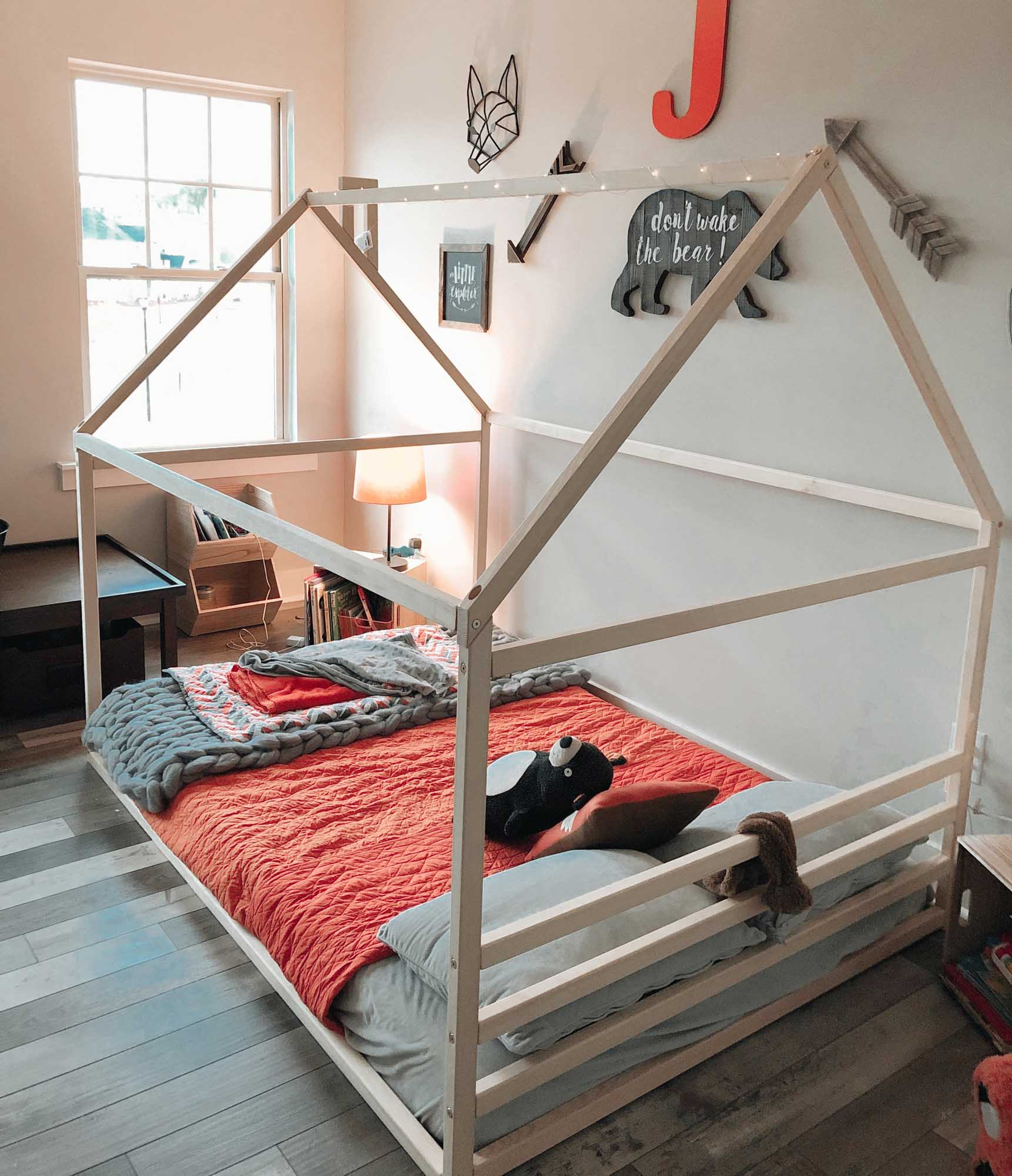 A Sweet Home From Wood Children's house bed with a cozy sleep haven and a wooden frame.