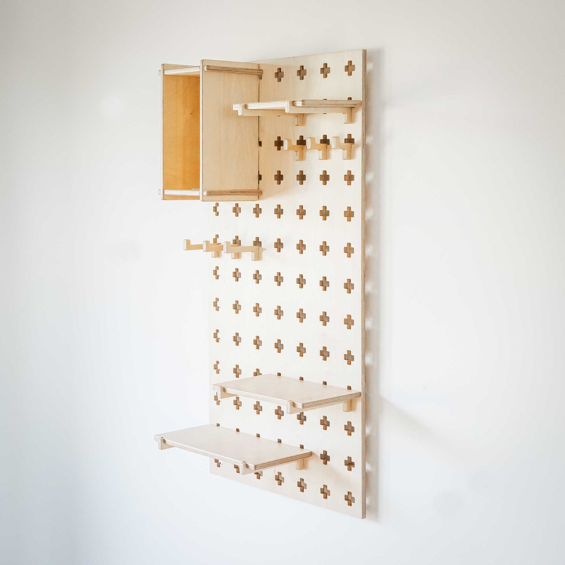 A Floating Shelves Pegboard on a white background providing open storage shelves for all your organizational needs.