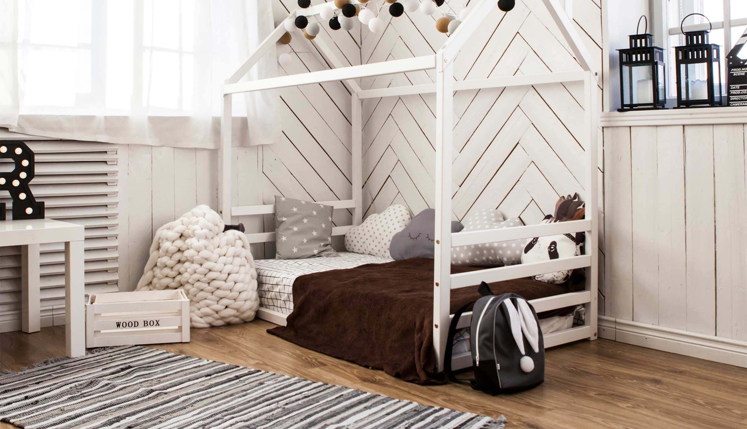 A child's room with a white canopy bed.