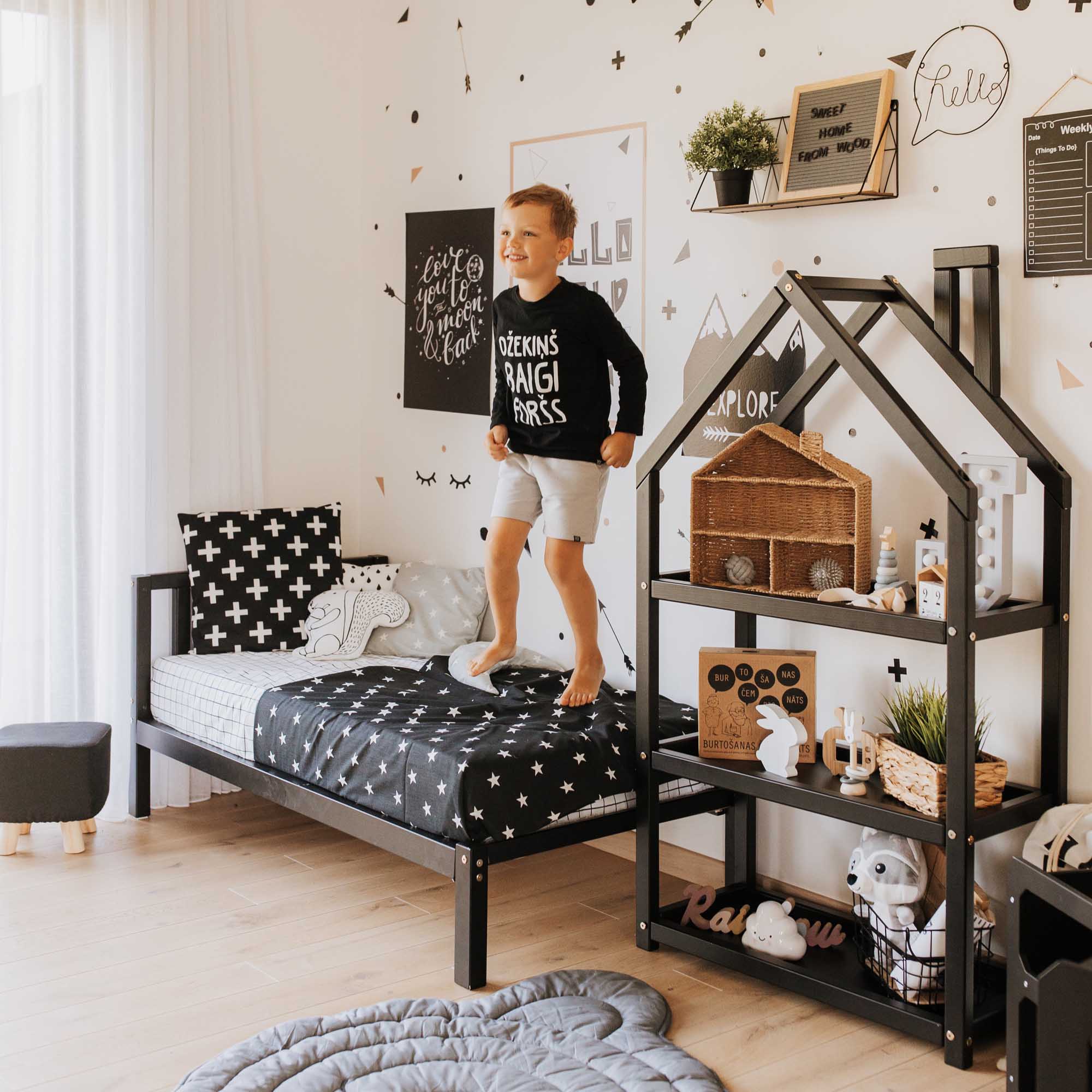 A boy's bedroom with black and white decor.