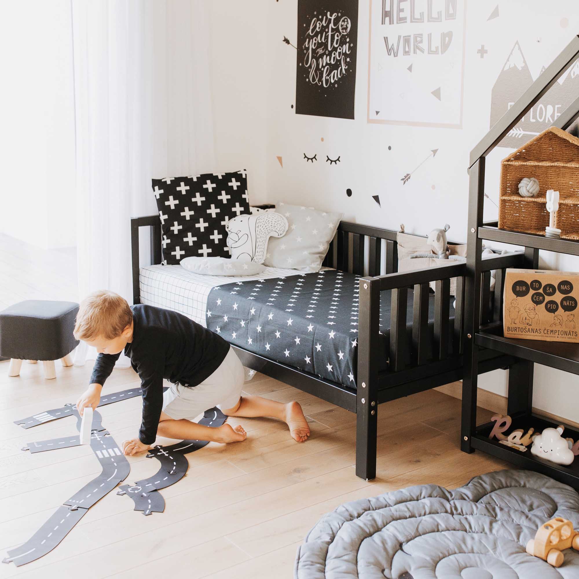 A boy's room with a bed and a rug.