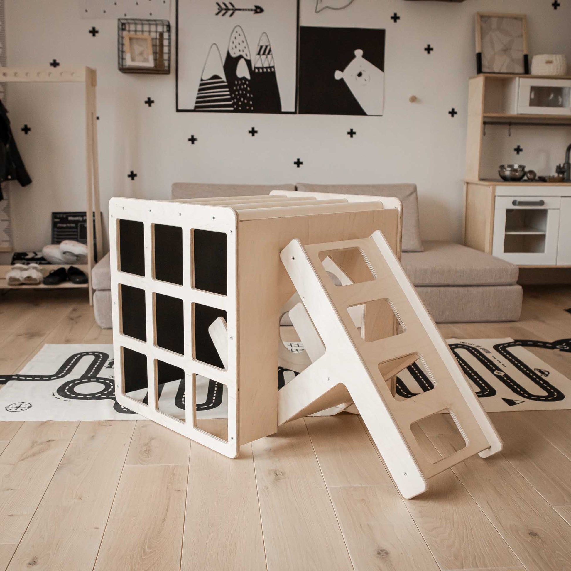 A child's playroom with a ladder and bookshelf featuring Sweet Home From Wood's Montessori 2-in-1 table and chair set or activity cube.
