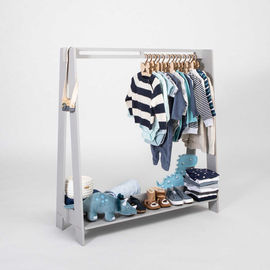 Sweet Home From Wood kids' clothing rack displaying baby's clothes.