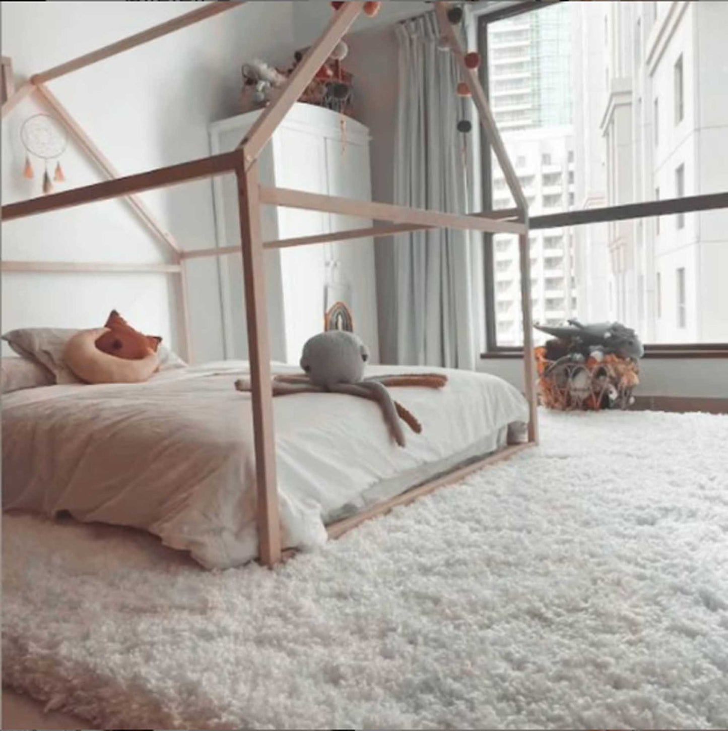 A Sweet Home From Wood Wooden zero-clearance house bed in a cozy sleep haven, adorned with a teddy bear.