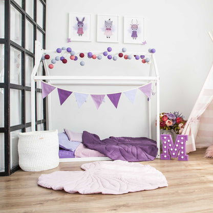A cozy sleep haven in a girl's room with a Sweet Home From Wood Wooden zero-clearance house bed and purple bunting.