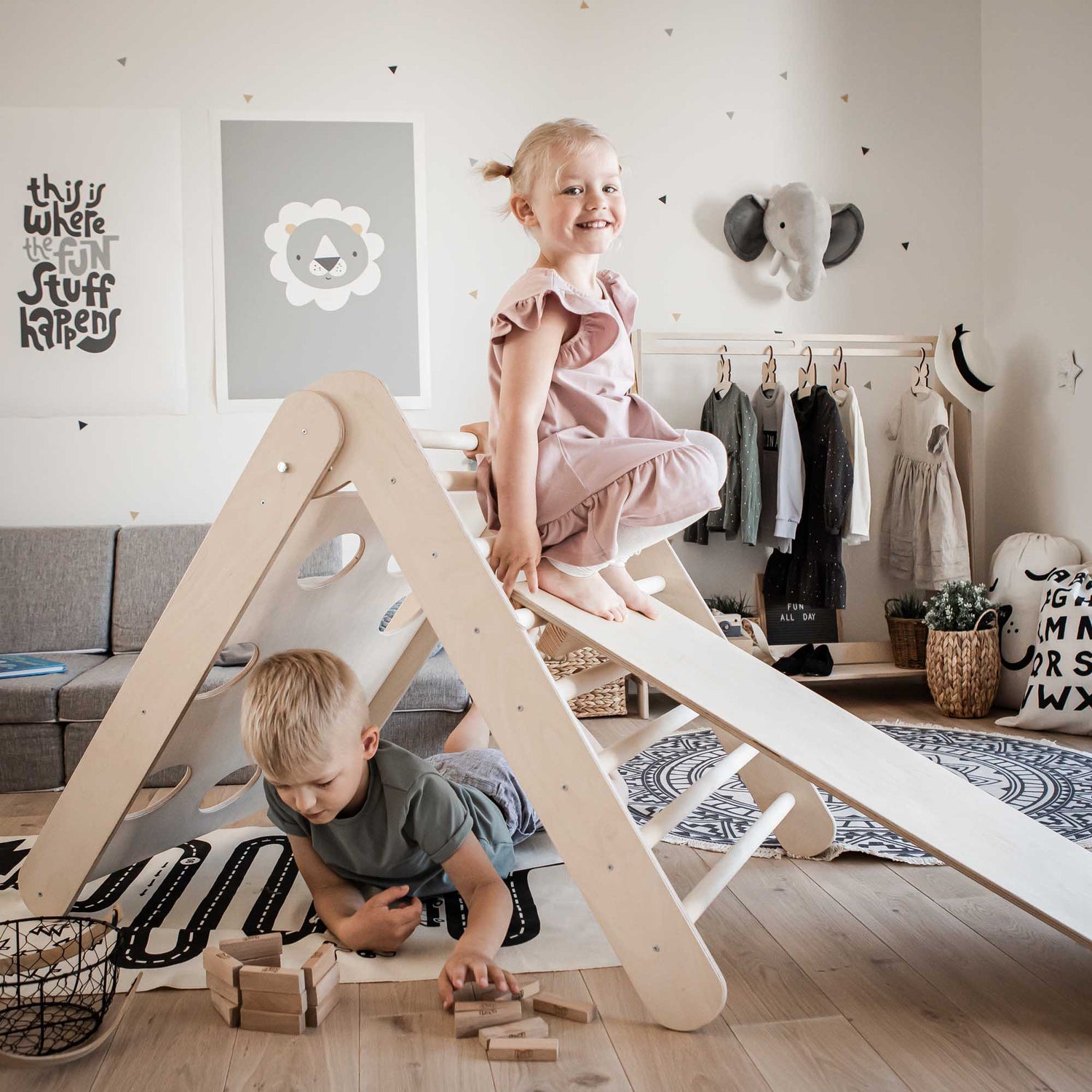 Two children playing on a transformable climbing triangle with 2 sensory panels in an indoor climber.