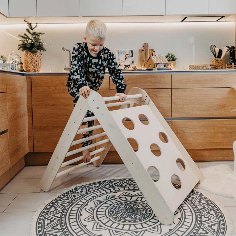 Instagram post photo with  a boy playing with toddler climbing triangle.