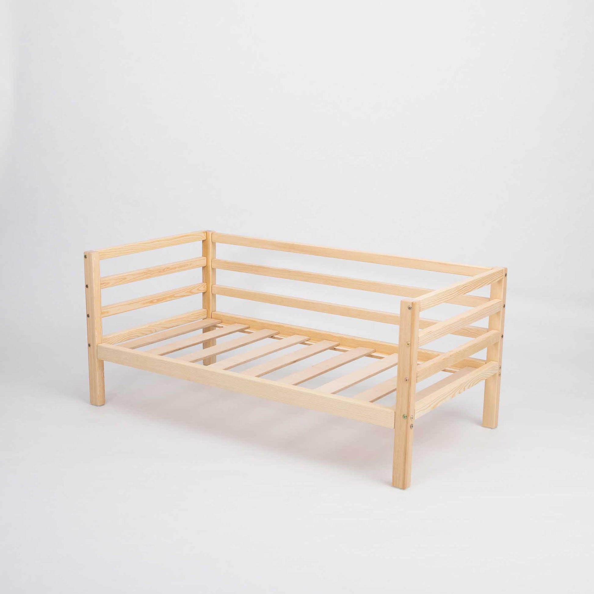 A Sweet Home From Wood kids' bed on legs with a 3-sided horizontal rail that grows with your child, featuring slats on a white background.