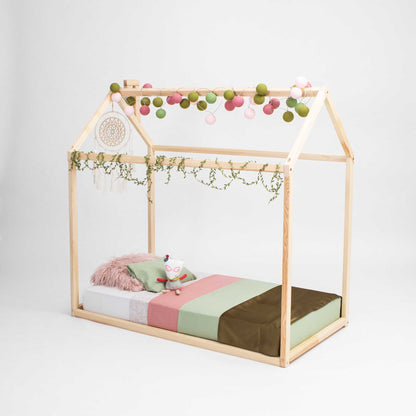A Wooden zero-clearance house bed from Sweet Home From Wood with a cozy sleep haven and a house-shaped canopy.