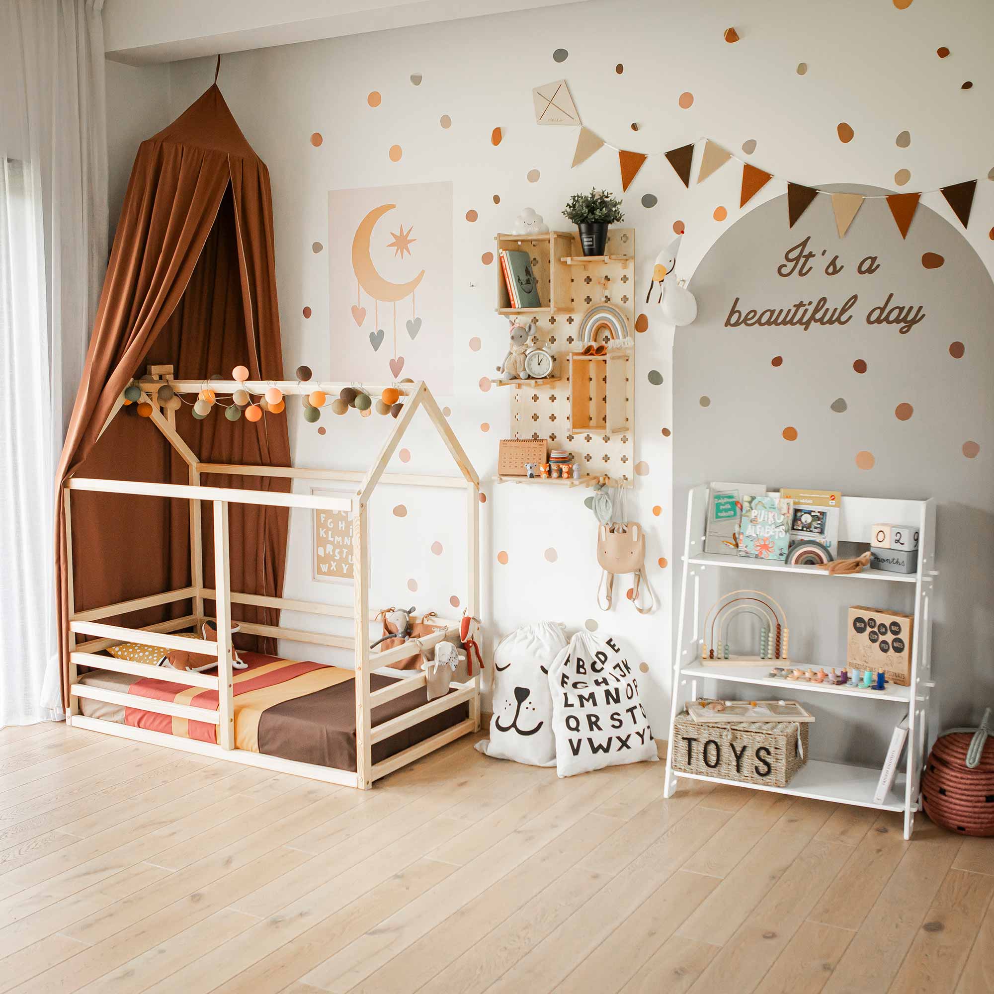 A Montessori toddler toy shelf with various office supplies and decorative items, neatly organized for a child's bedroom.