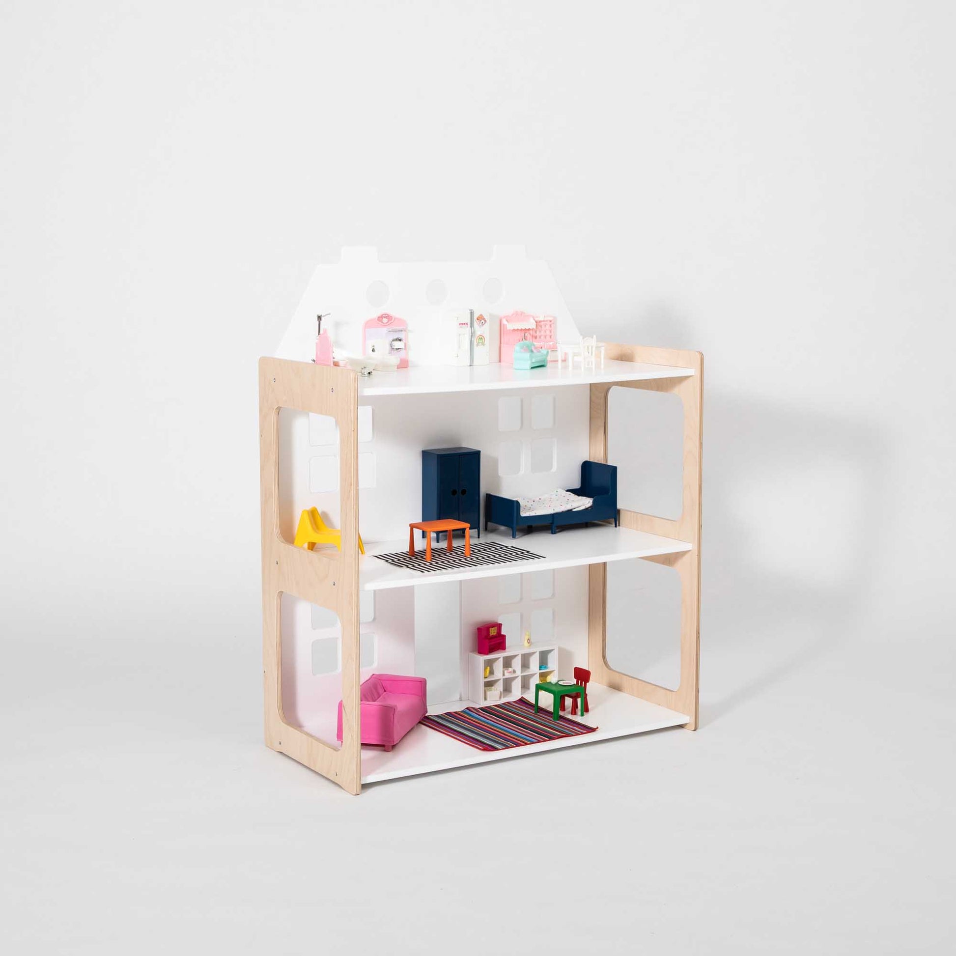 Dollhouse on a white background filled with doll furniture
