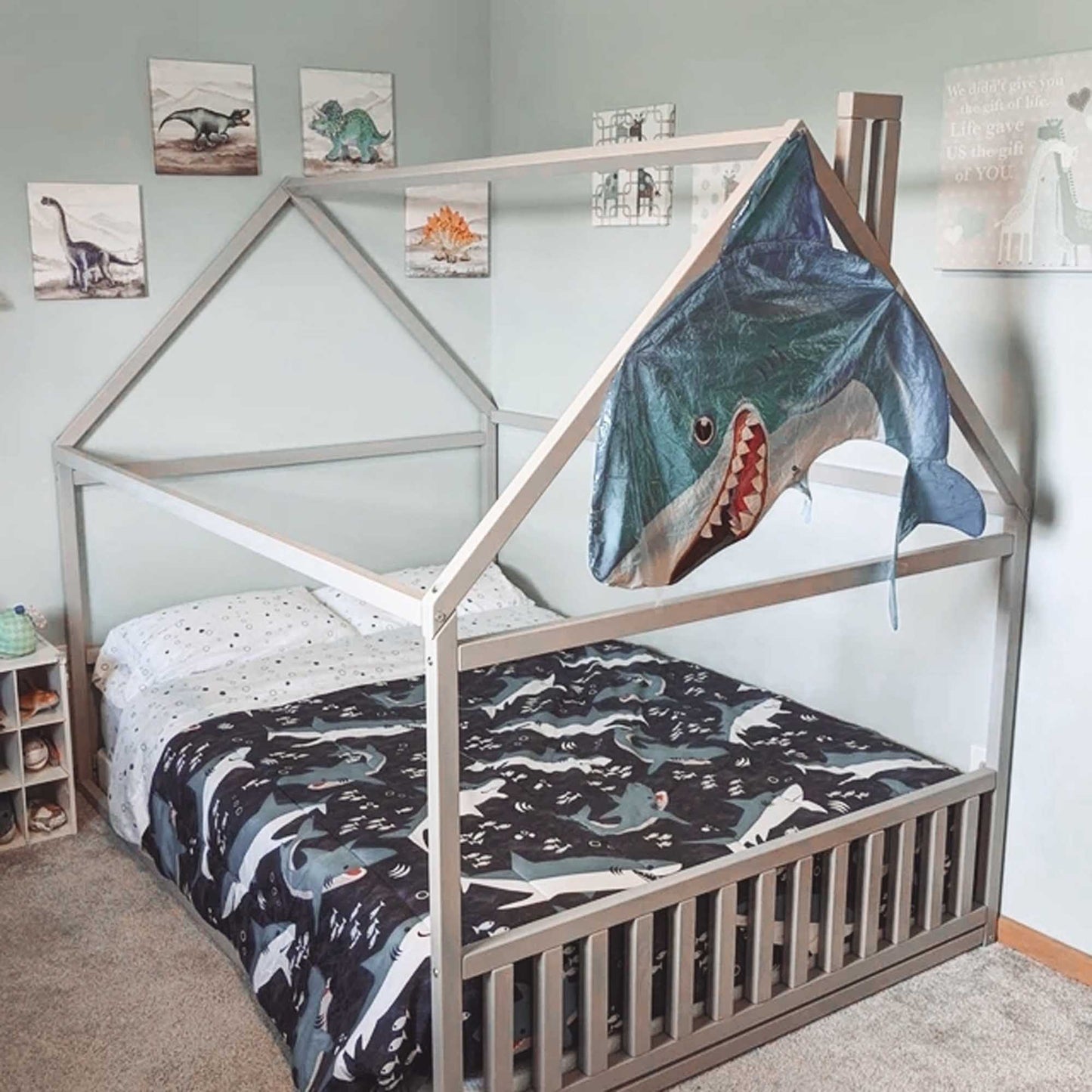 A cozy sleep haven for a child, featuring a Sweet Home From Wood toddler house bed with a headboard and footboard.