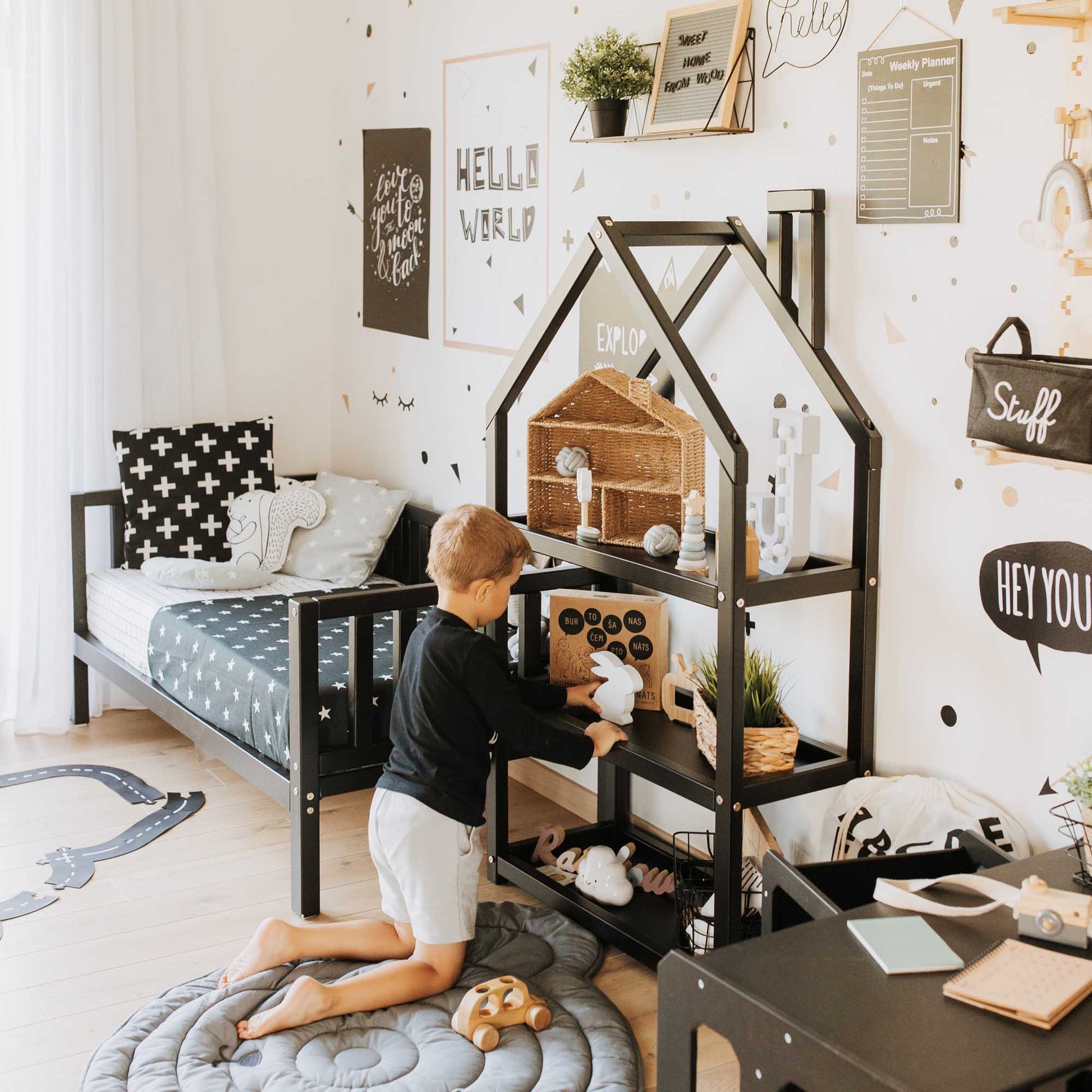 A boy's room with an open House-shaped Montessori shelf from Sweet Home From Wood.