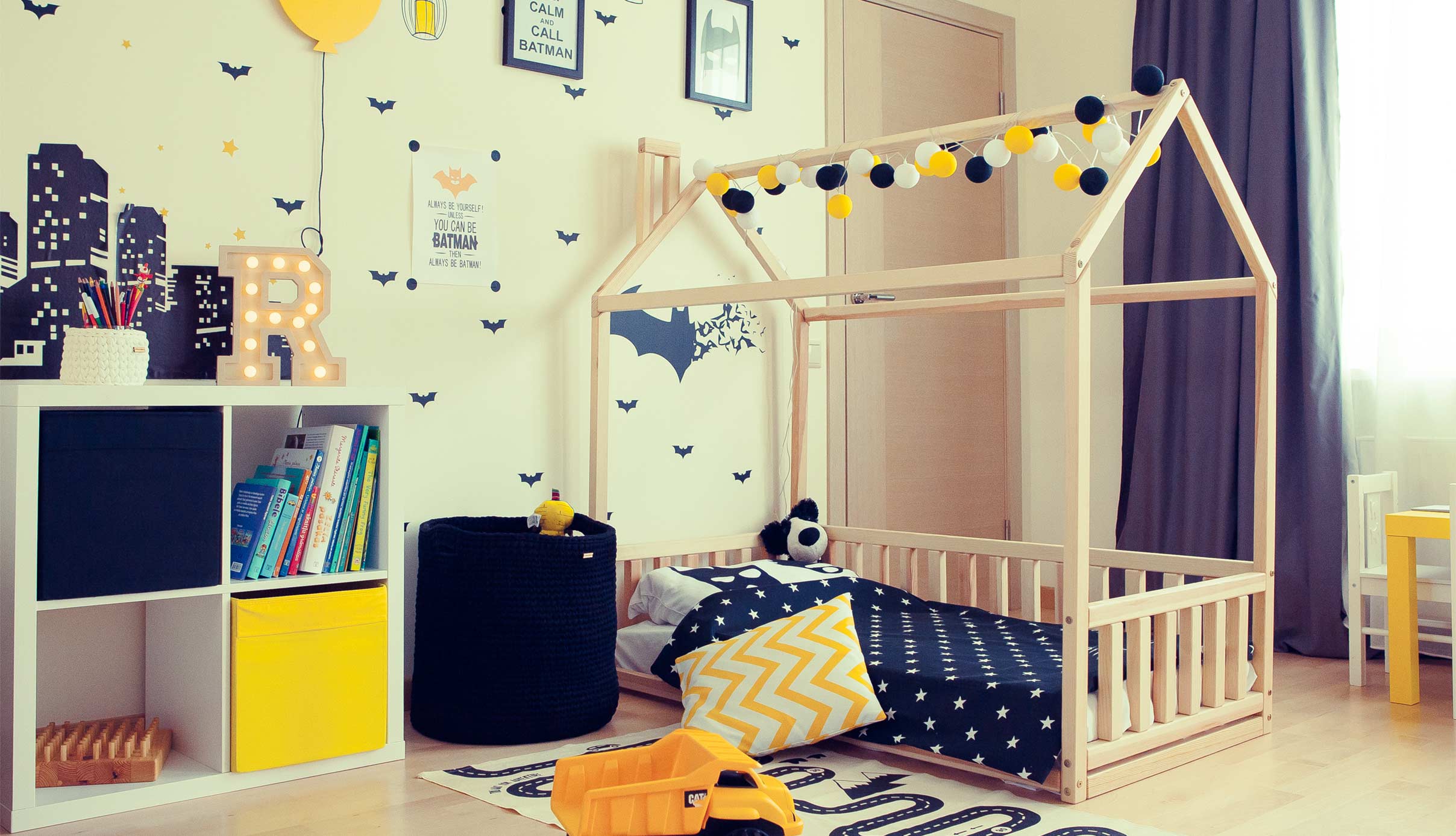 A children's room with a bed and a bedside table.