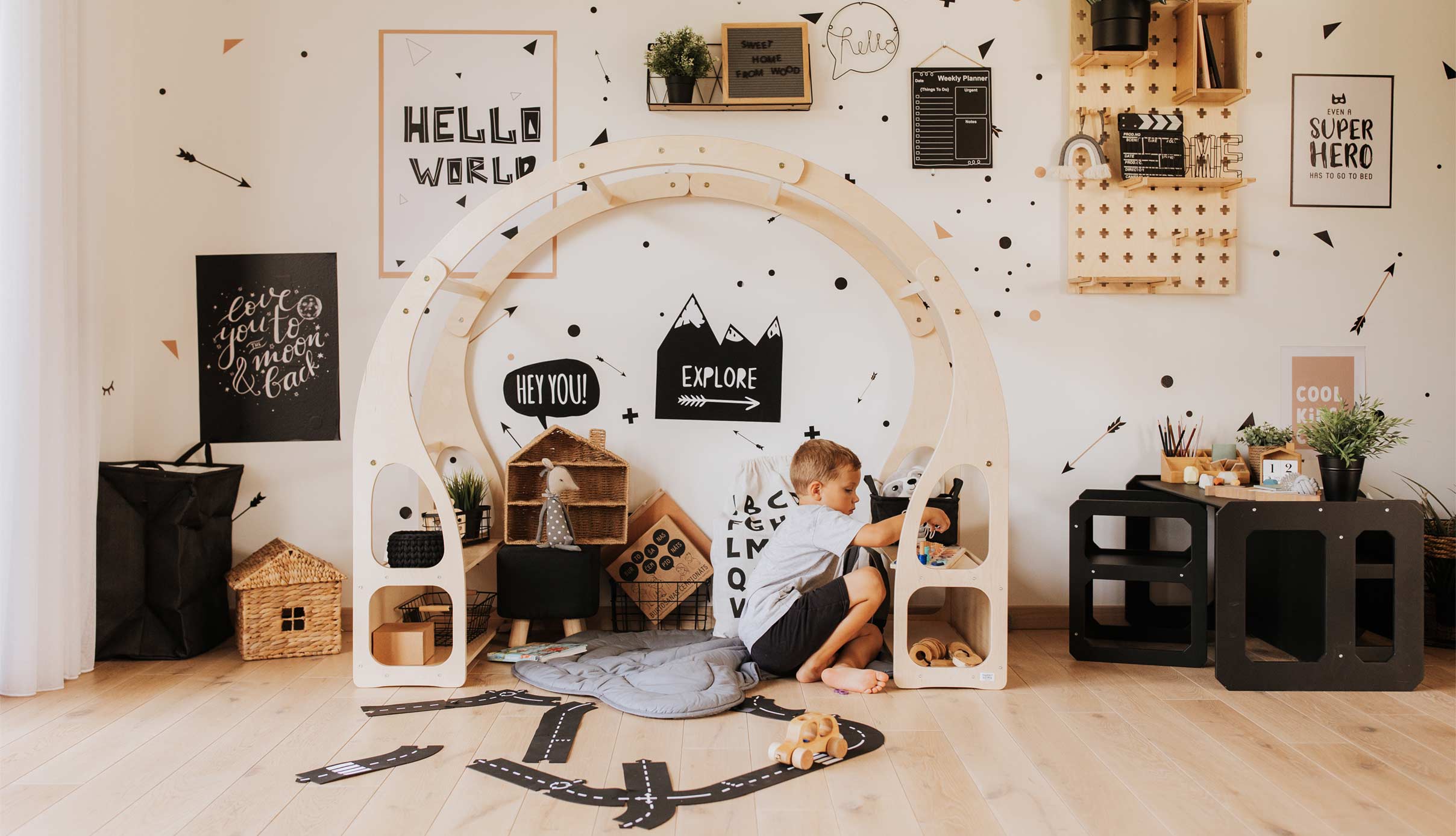 A child's room with a black and white play area.