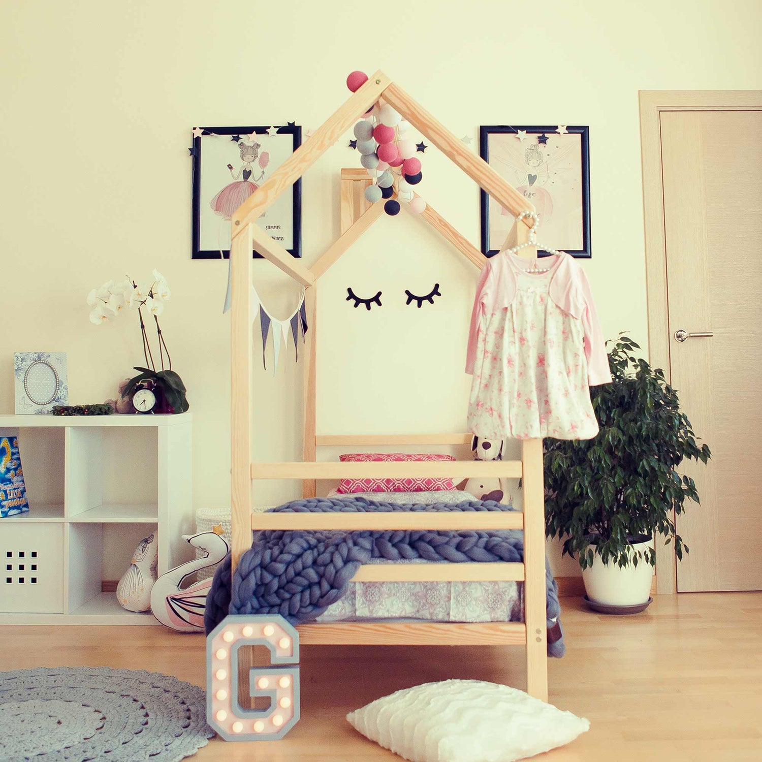 A child's bedroom with a wooden bed frame.