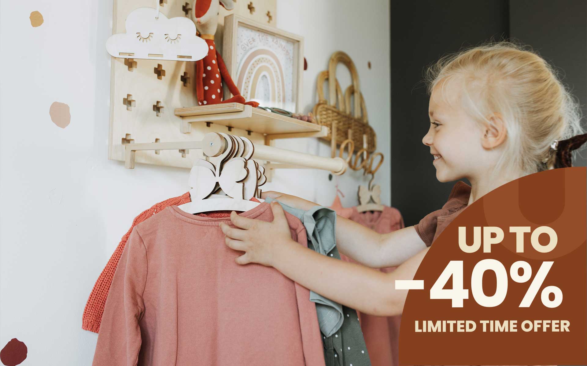 A girl hanging her clothes on floating pegboard shelf.