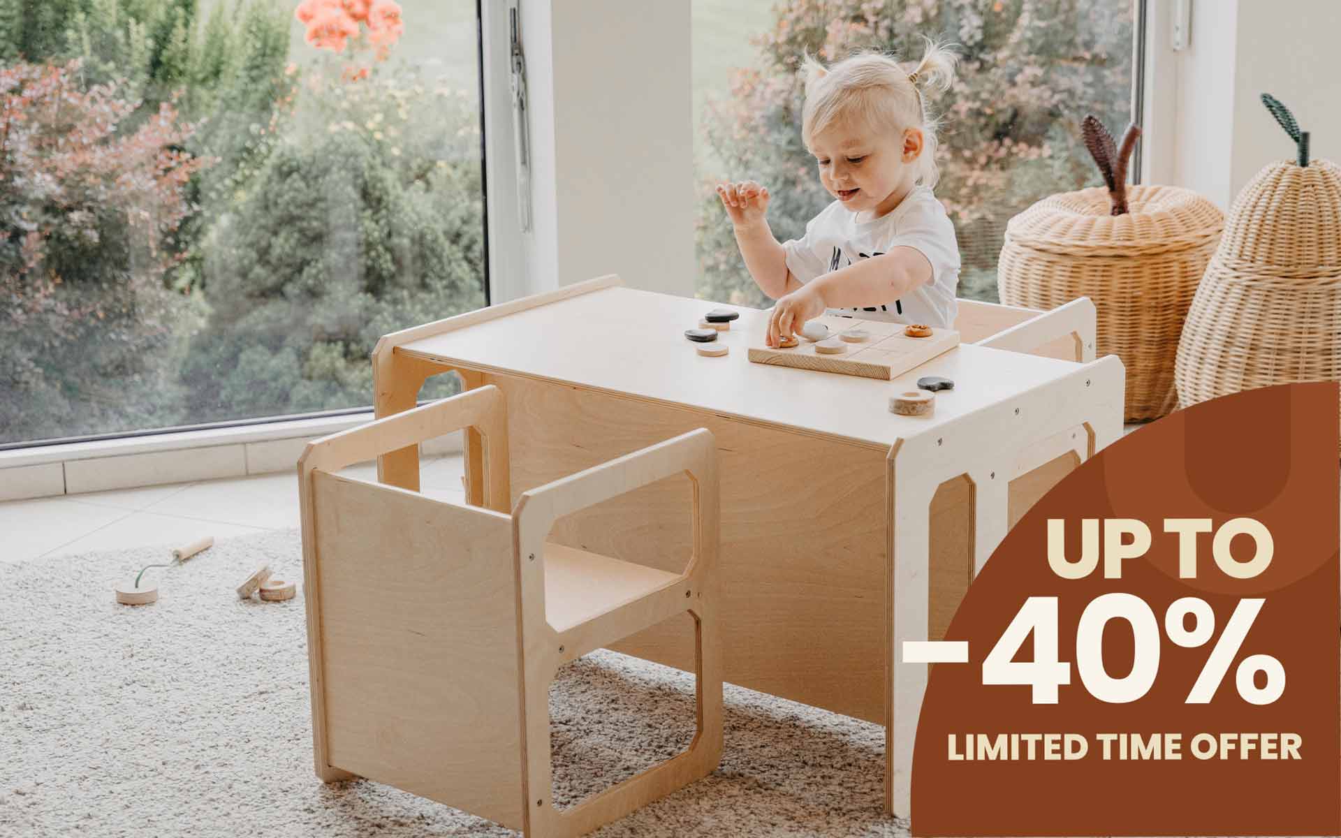 A girl sitting and playing in a Montessori weaning table and 2 chair set.