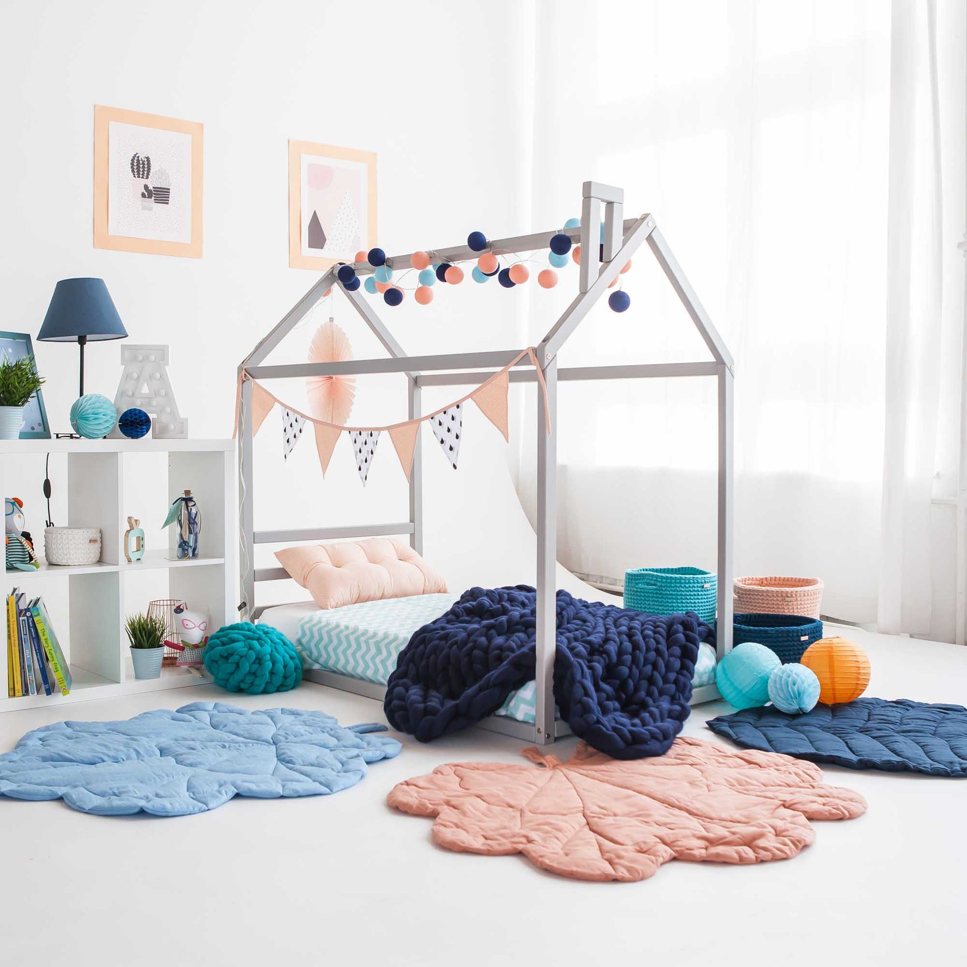 A cozy sleep haven for a child, featuring a "Sweet Home From Wood" Montessori house bed with a horizontal rail headboard and a comfy rug.