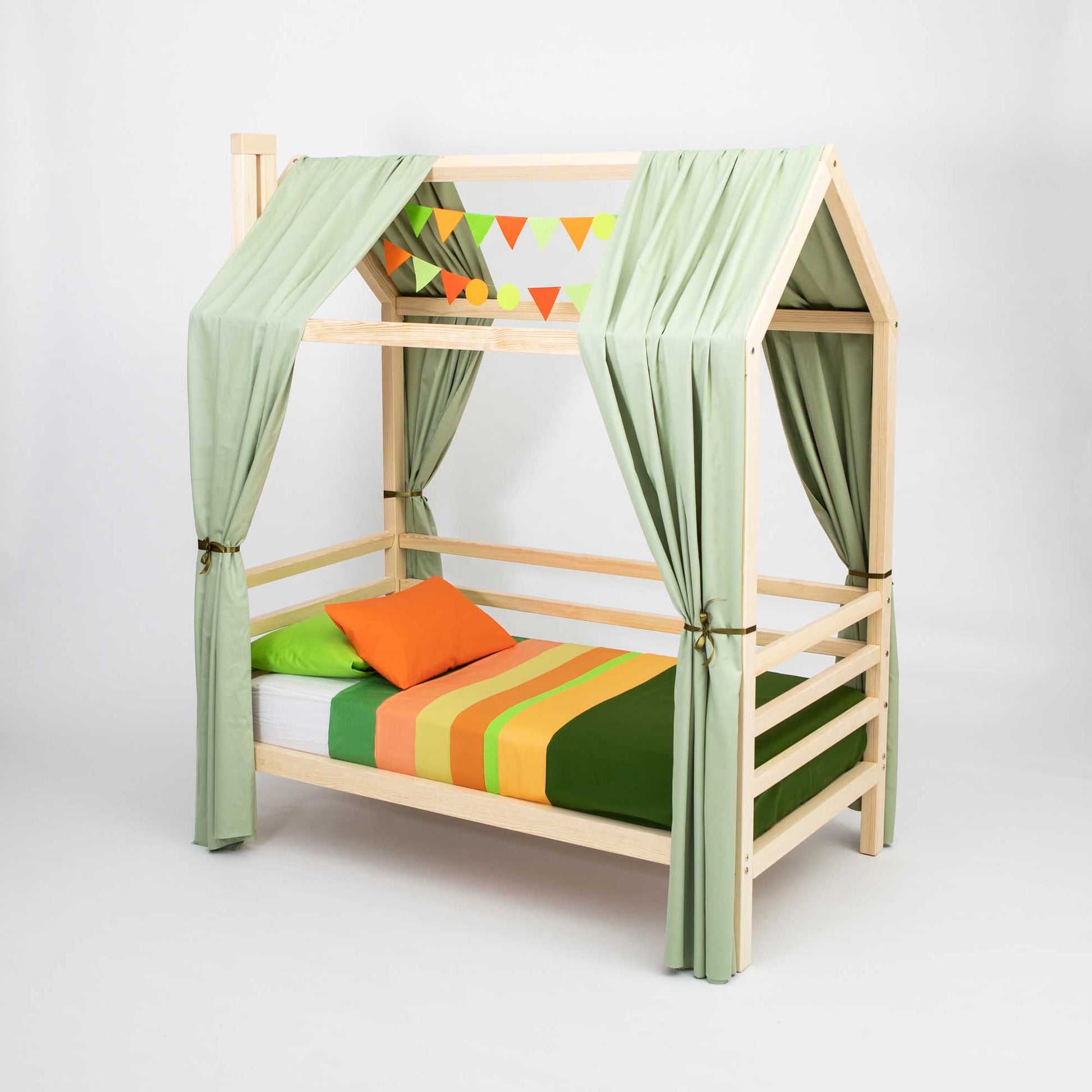 Children's house bed on legs with 3-sided rails, featuring a wooden frame, green curtains, and colorful bedding; the top bunk boasts a charming toddler house-shaped design with triangular bunting decorations, creating a cozy sleeping space.
