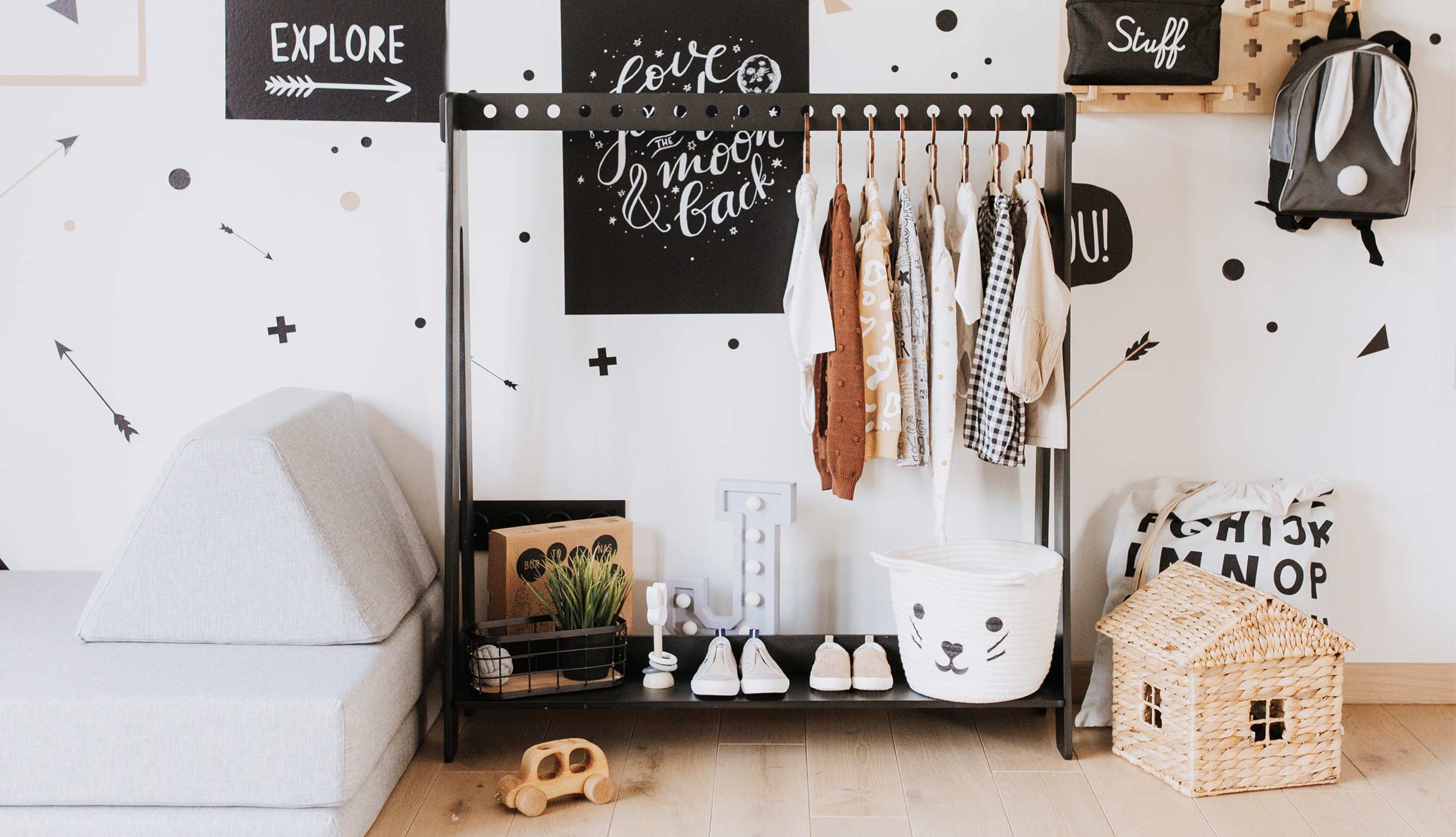 A child's room with a black and white polka dot wall.