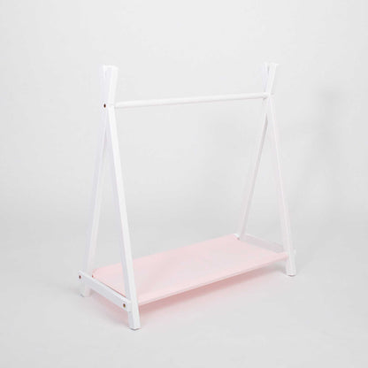 A white Kids' clothing rack with storage featuring a pink shelf for Montessori-inspired storage.