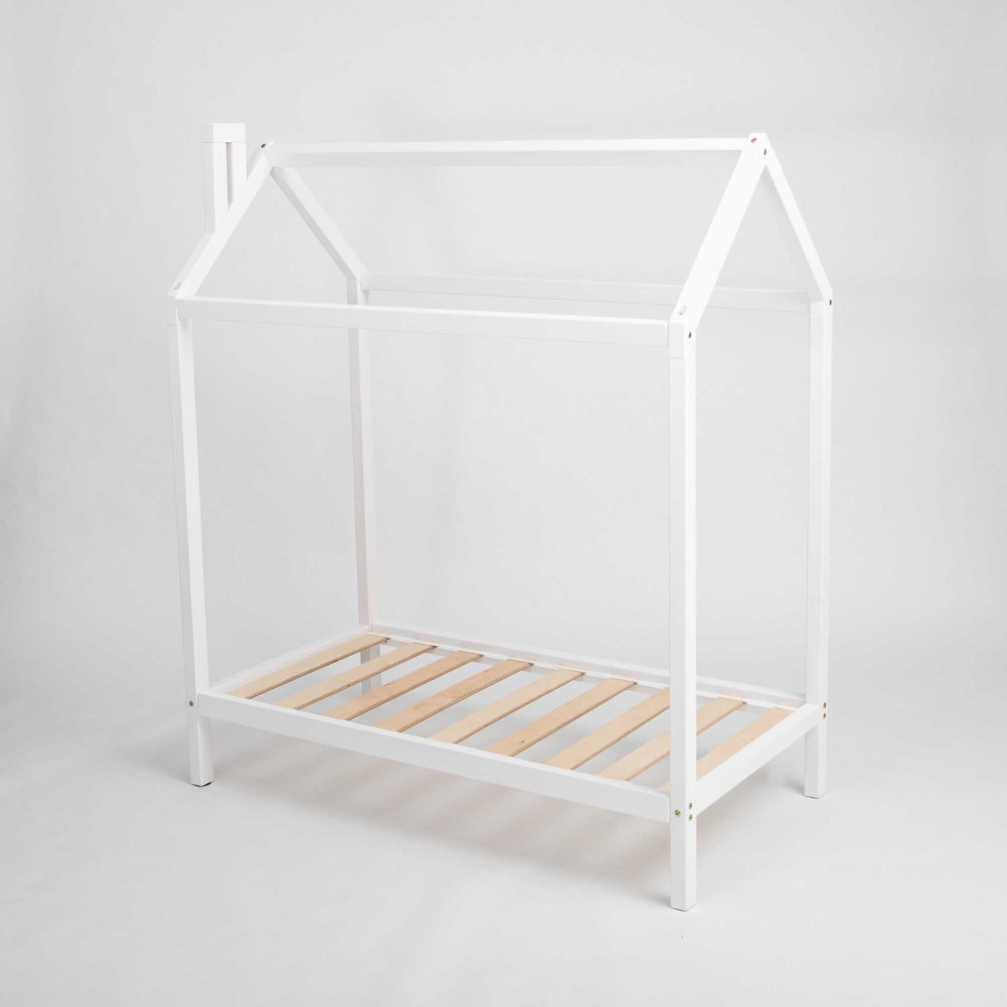 A white raised wooden house bed on legs with wooden slats.