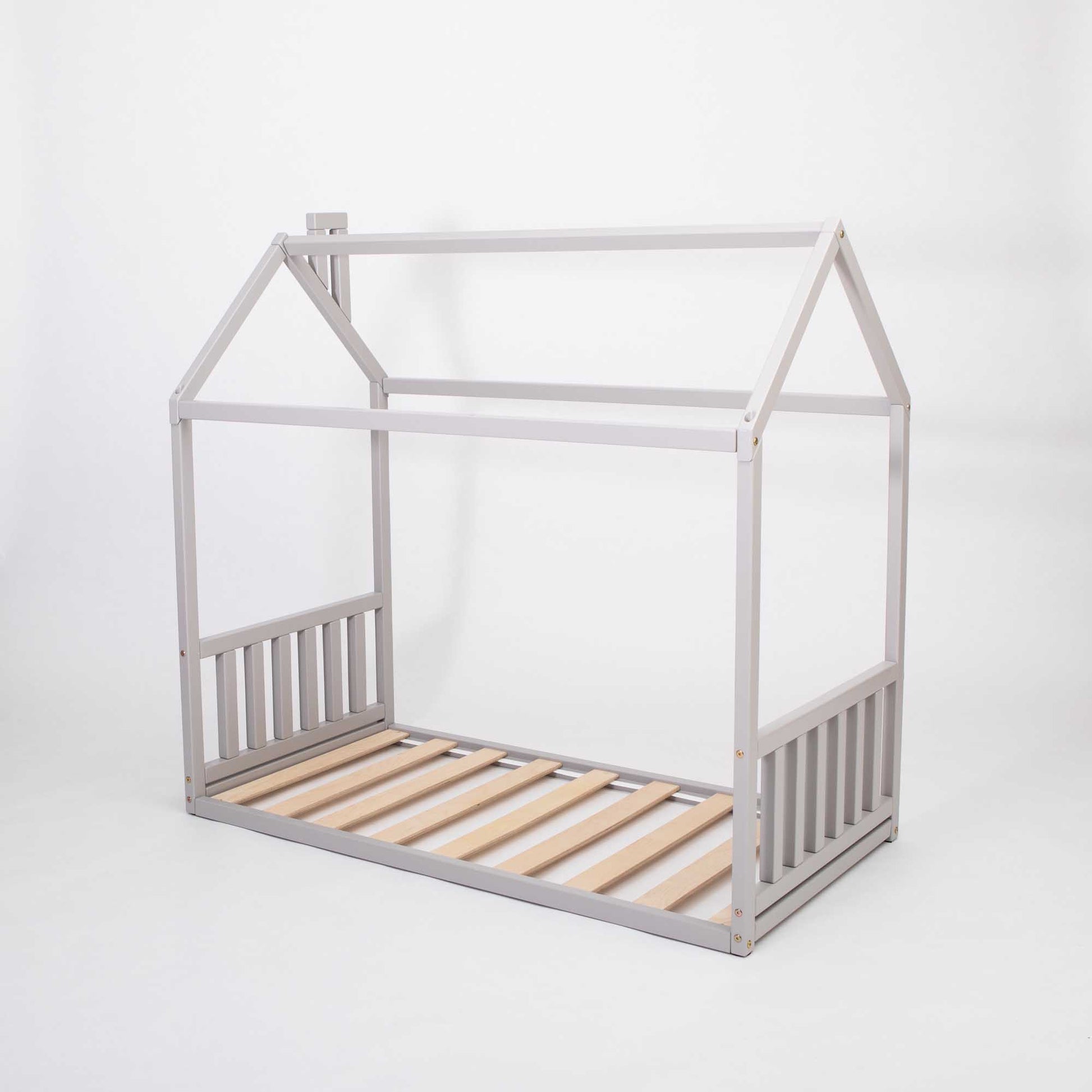 A cozy sleep haven resembling a Sweet Home From Wood Toddler House Bed, equipped with a wooden slatted frame.