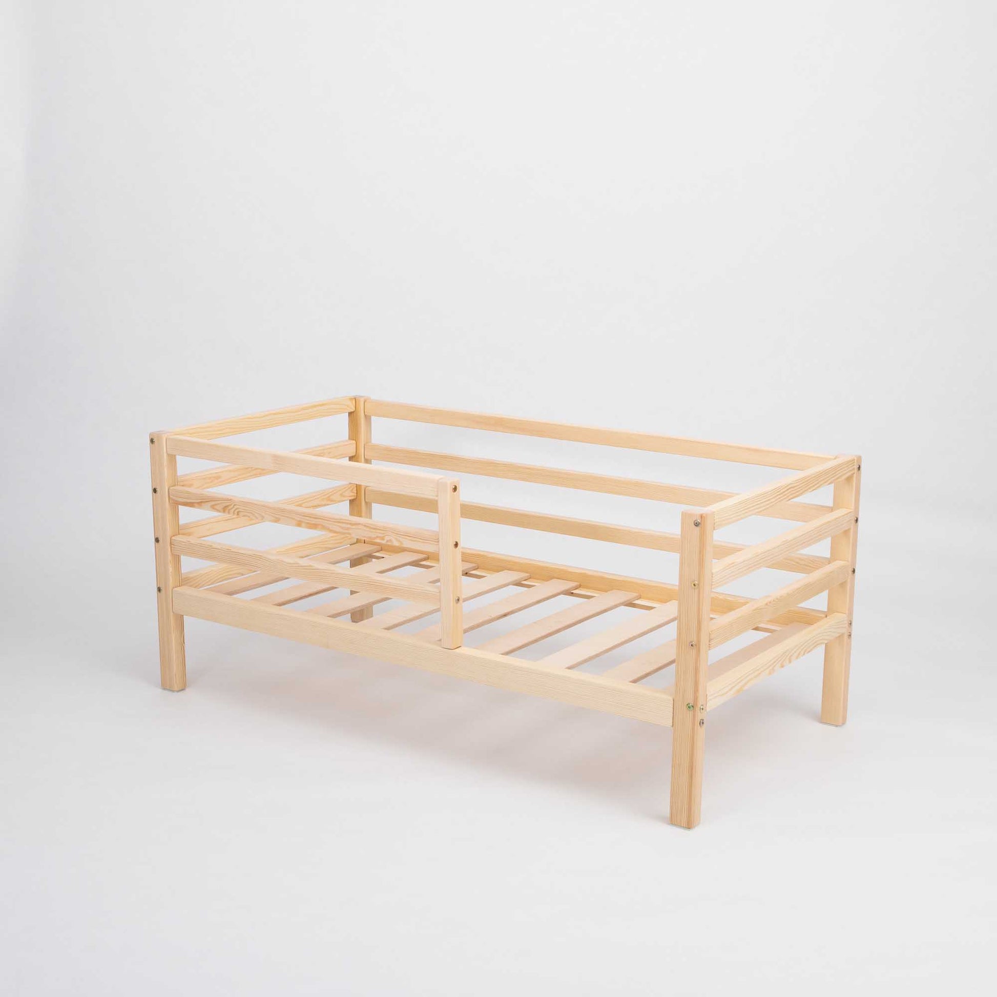 A Sweet Home From Wood Kids' bed on legs with a horizontal rail fence and slatted frame.