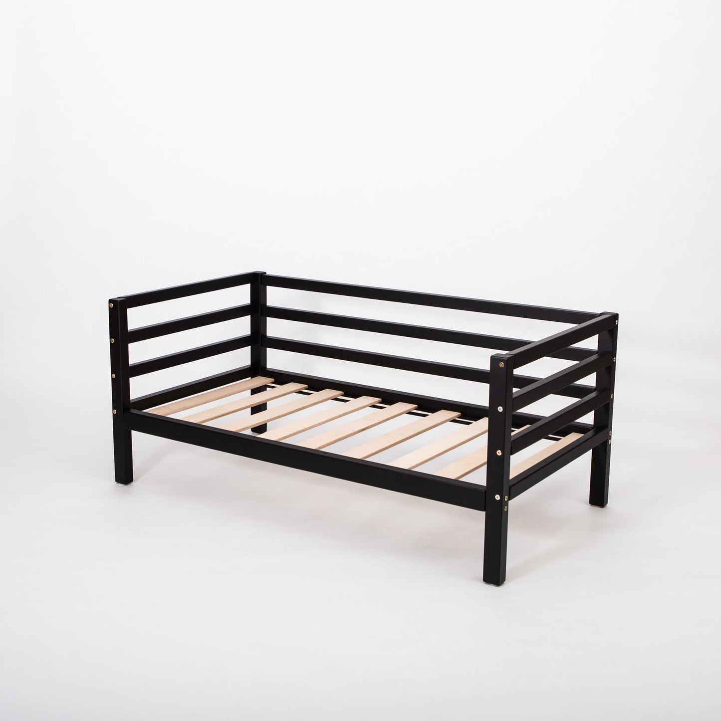 A Kids' bed on legs with horizontal rails on three sides, featuring a black metal frame and solid wood mattress support slats, Montessori-inspired and photographed against a plain white background.