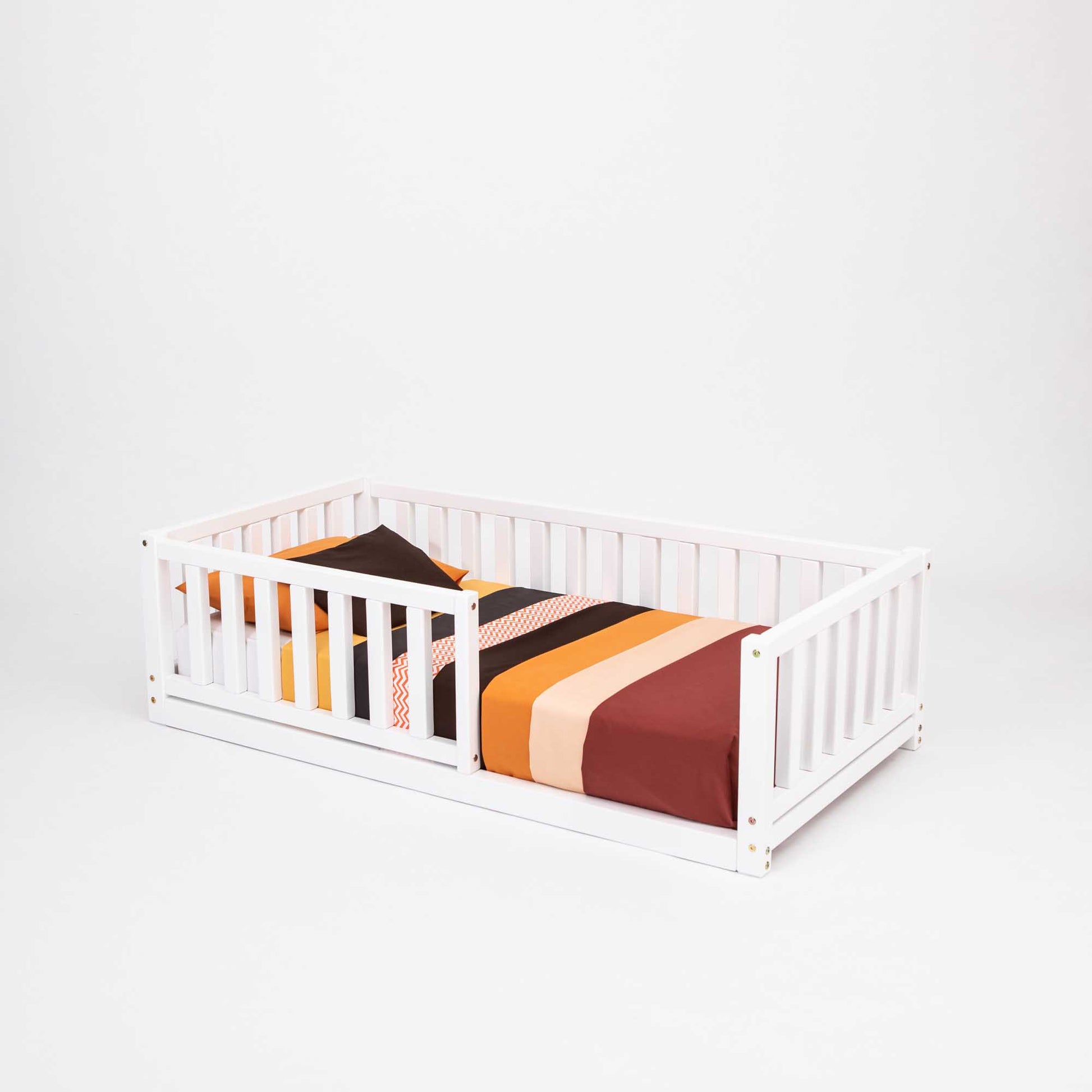 A long-lasting 2-in-1 toddler bed on legs with a vertical rail fence made of solid pine, with striped sheets covering it by Sweet Home From Wood.