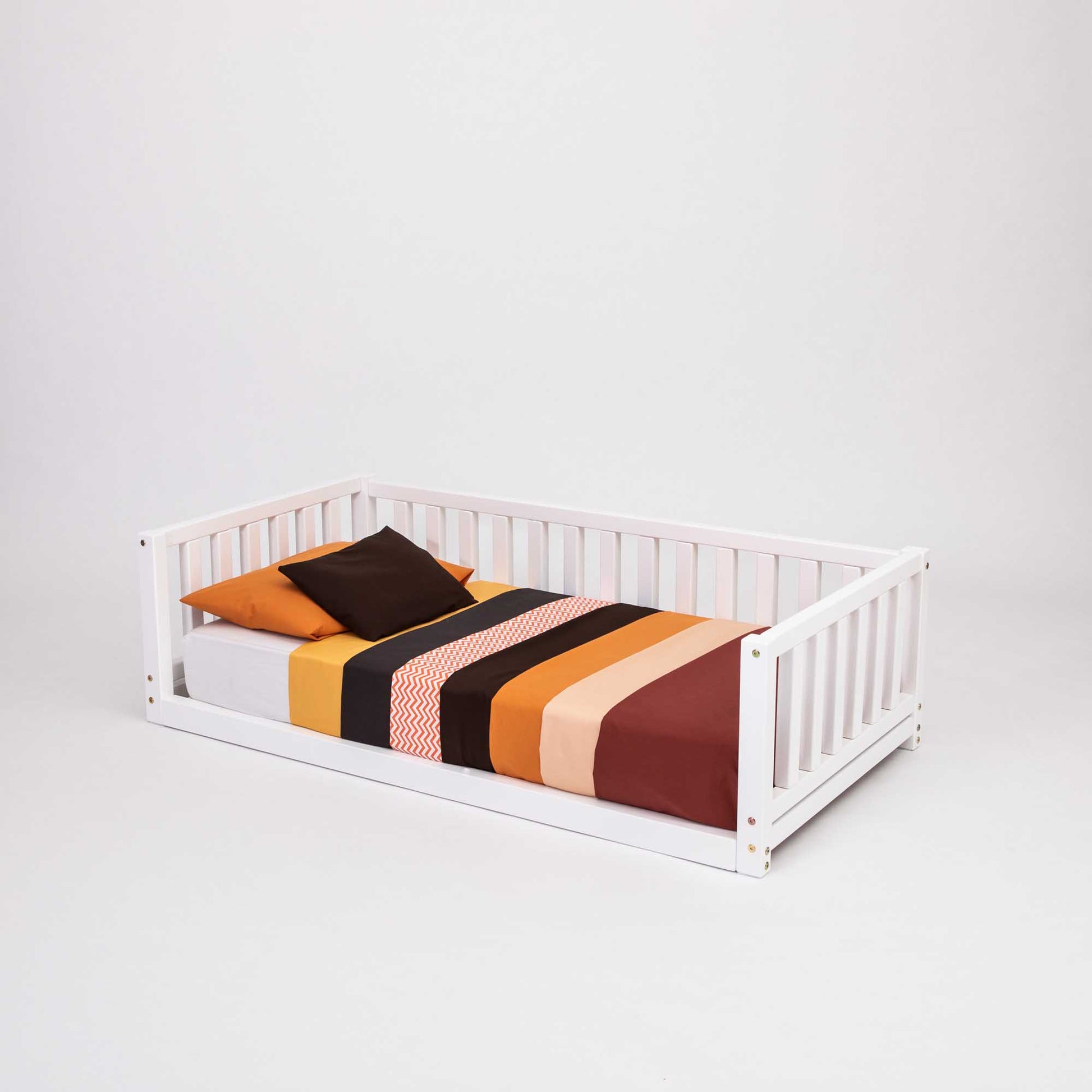 A Montessori bed with 3-sided rails from Sweet Home From Wood, perfect for young children transitioning from a crib.