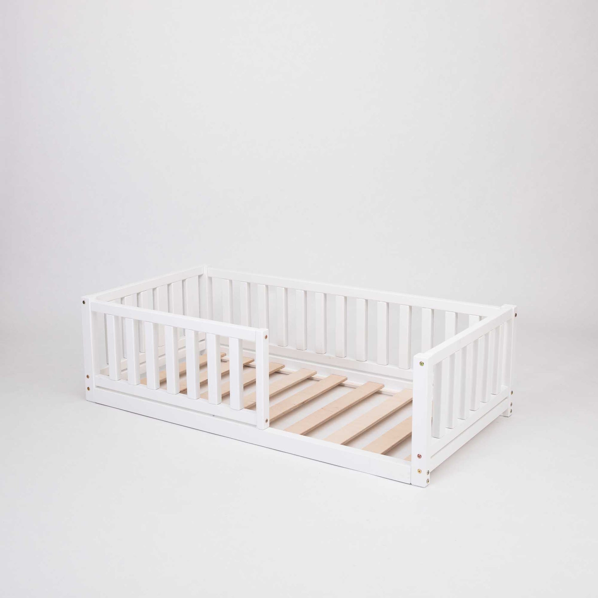 A Sweet Home From Wood Montessori kids' bed with a fence, designed to provide security and encourage independent sleeping.