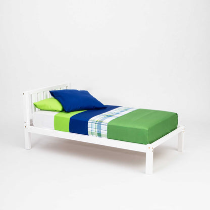 A Sweet Home From Wood Kids' bed on legs with a headboard, with a white frame and a green and blue comforter.