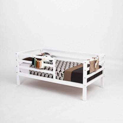 This 2-in-1 transformable kids' bed with a horizontal rail fence features a bookcase on it, produced by Sweet Home From Wood.