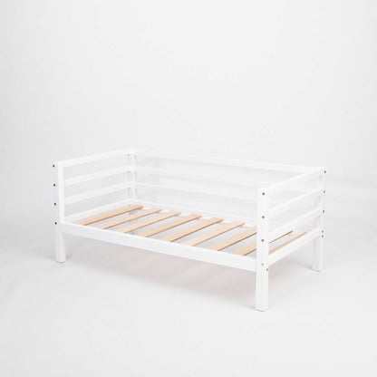 A Kids' bed on legs with a 3-sided horizontal rail from Sweet Home From Wood, against a white background, suitable for a toddler.