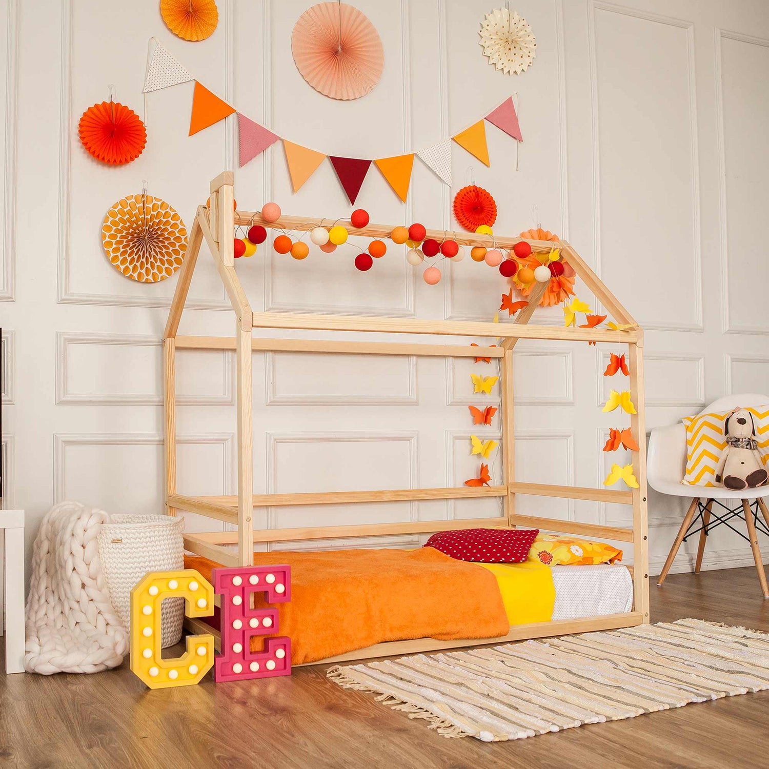 A child's room with a wooden bed and decorations.