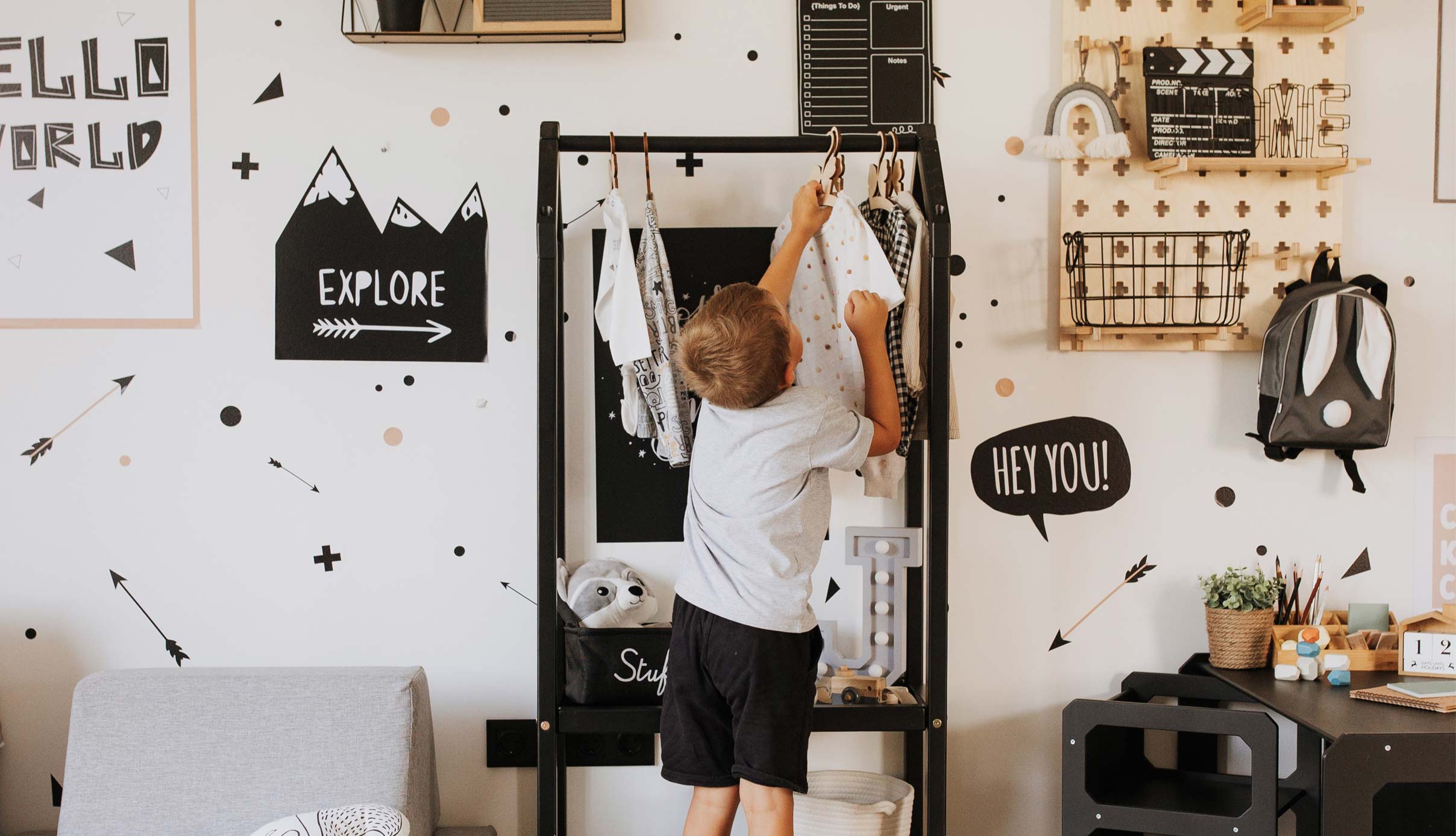 A boy in a room with black and white decor.