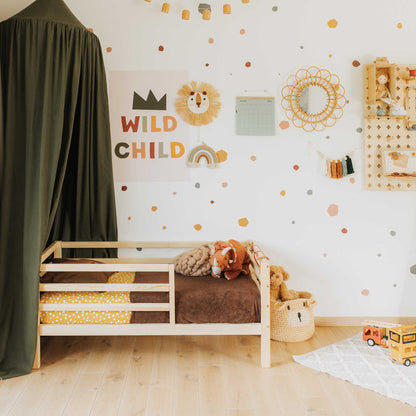 A child's room with a Sweet Home From Wood kids' bed on legs with a horizontal rail fence and teddy bears.