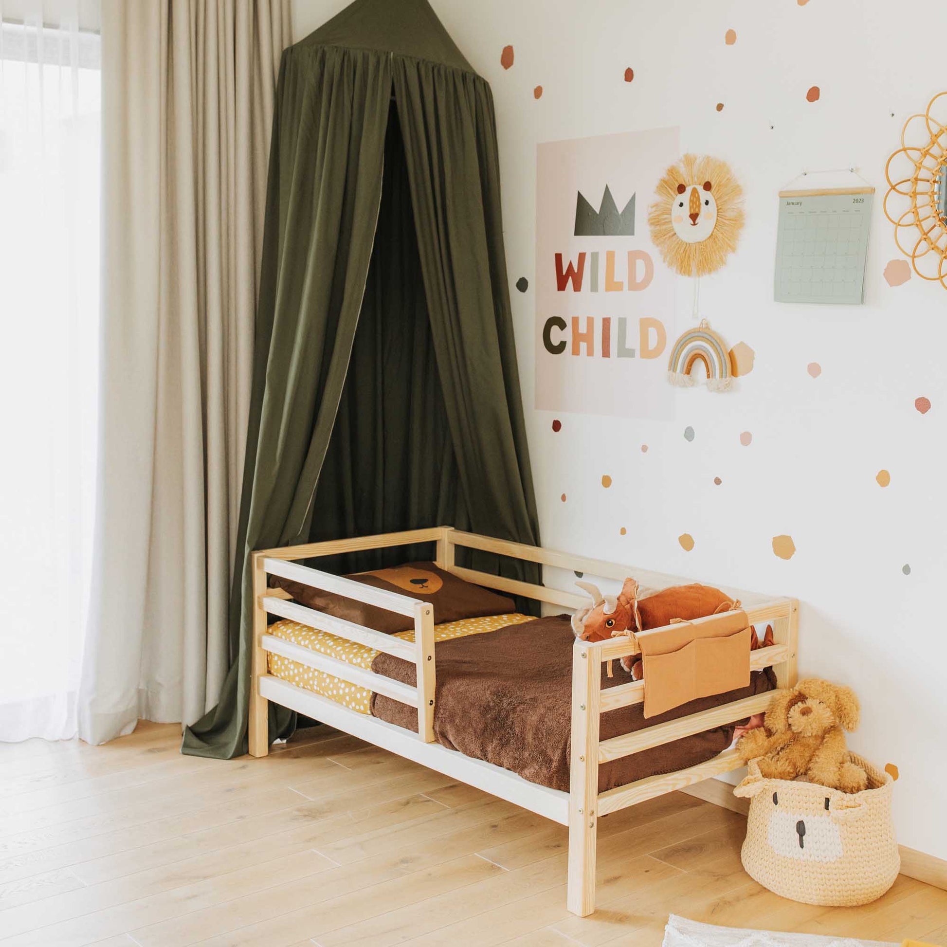 A child's room with a canopy and teddy bears, featuring the Sweet Home From Wood Kids' bed on legs with a horizontal rail fence.