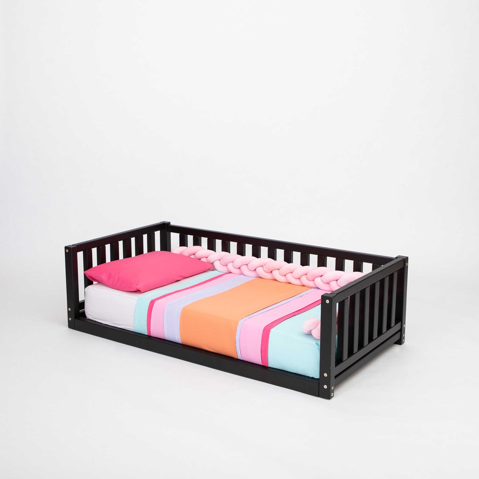 A Sweet Home From Wood 2-in-1 toddler bed on legs with a 3-sided vertical rail, with a colorful blanket on a solid pine or birch wood frame.