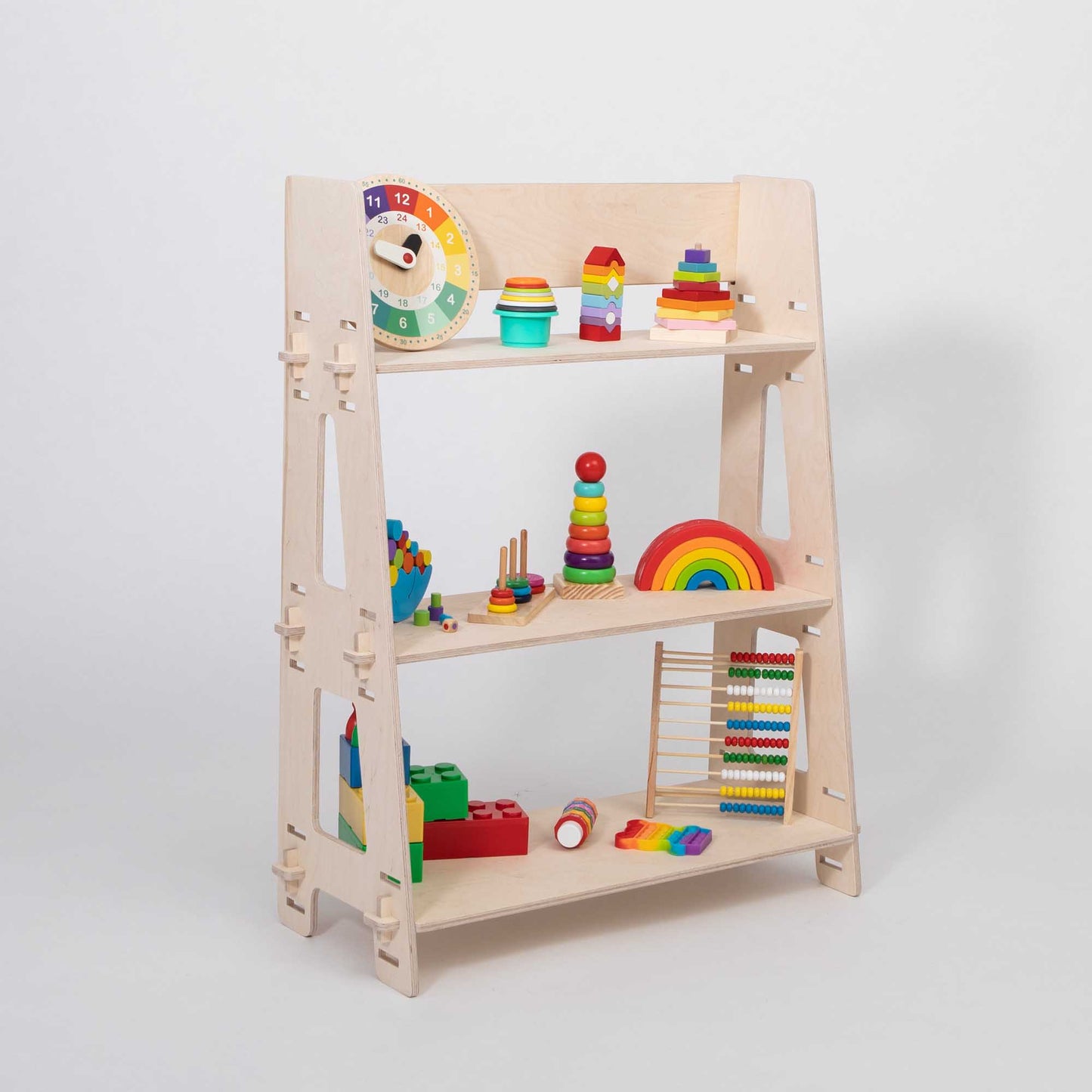 A wooden Montessori toy shelf organized with various colorful educational toys, including blocks, rings, and a clock, ideal for a children's bedroom.