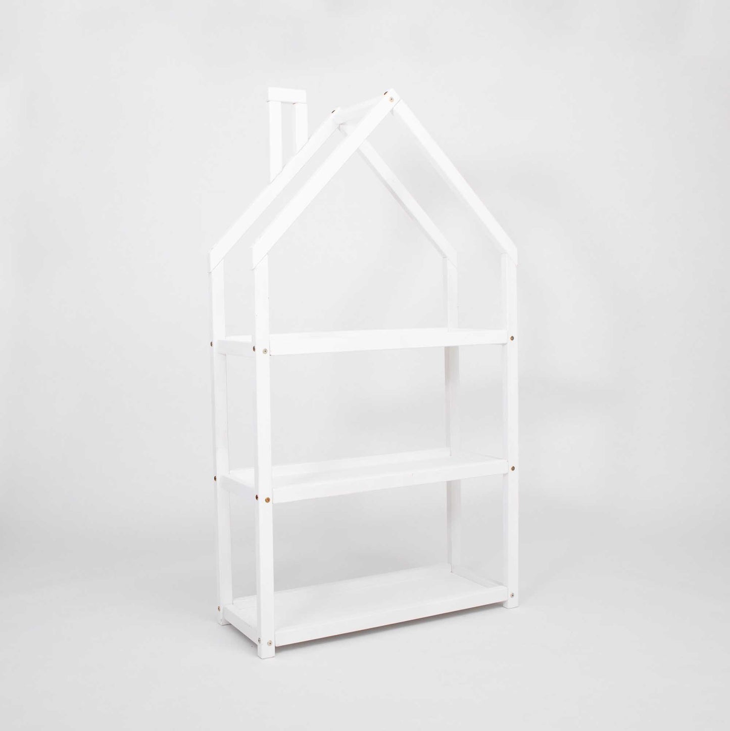 A white House-shaped Montessori shelf from Sweet Home From Wood with a doll house on it.