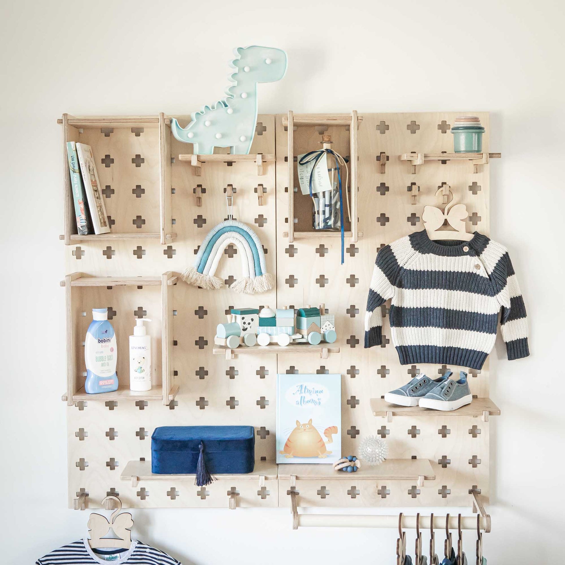 A boy's room with open storage shelves and a Sweet HOME from wood Large Pegboard Shelf with Clothes Hanger.