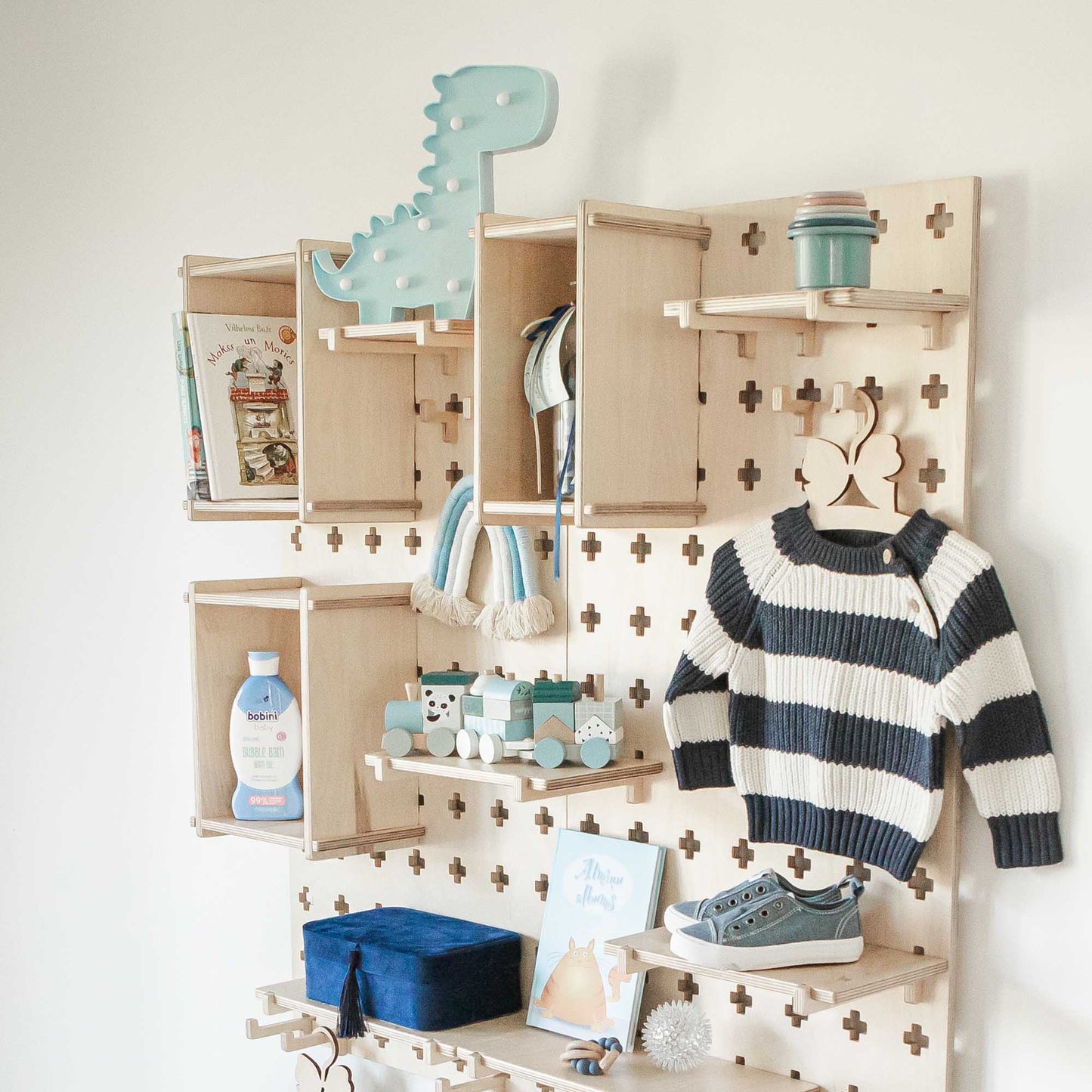 A baby's room with an open storage Sweet HOME from wood Large Pegboard Display Stand.
