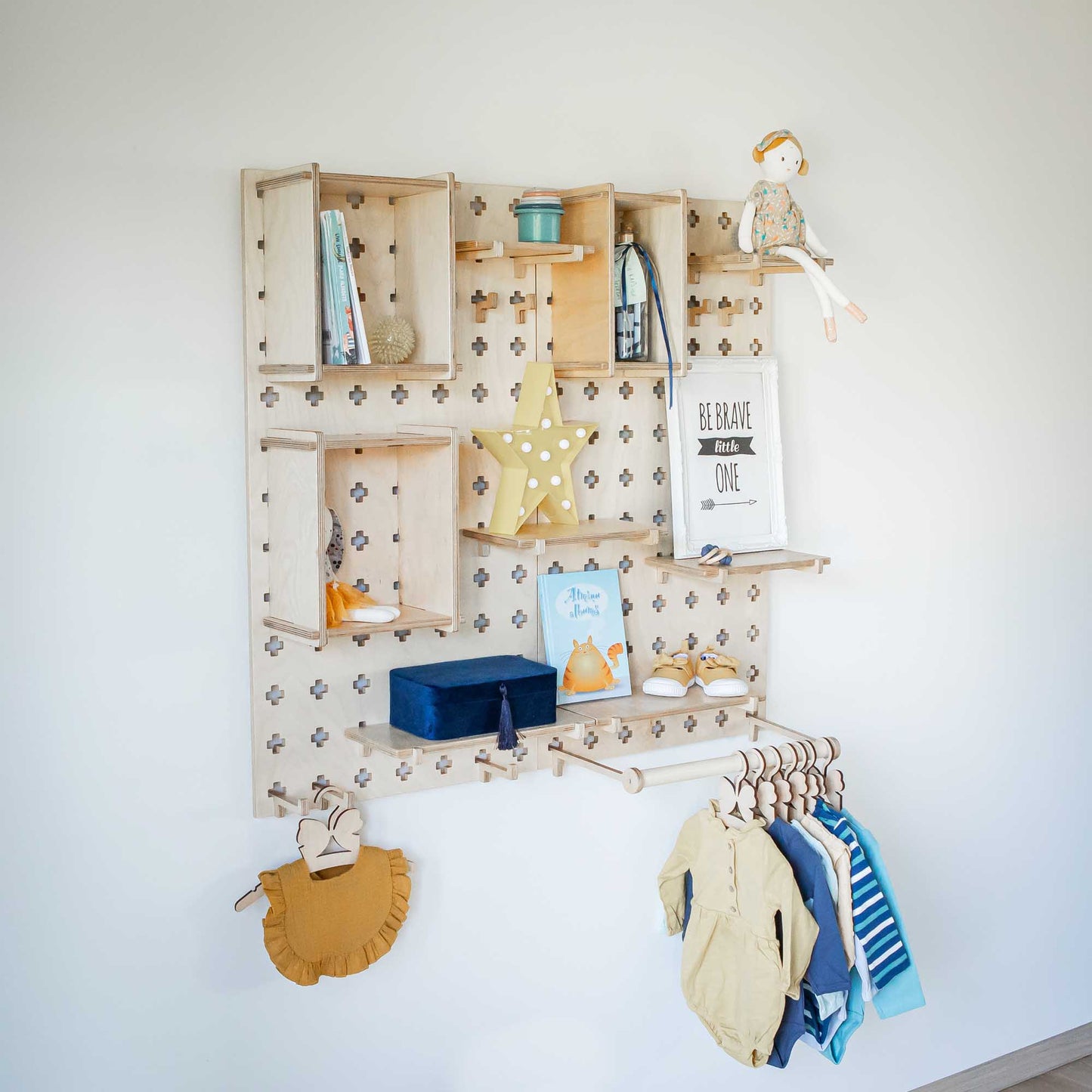 A Sweet HOME from wood Large Pegboard Shelf with Clothes Hanger wall mounted in a child's room for open storage shelves.